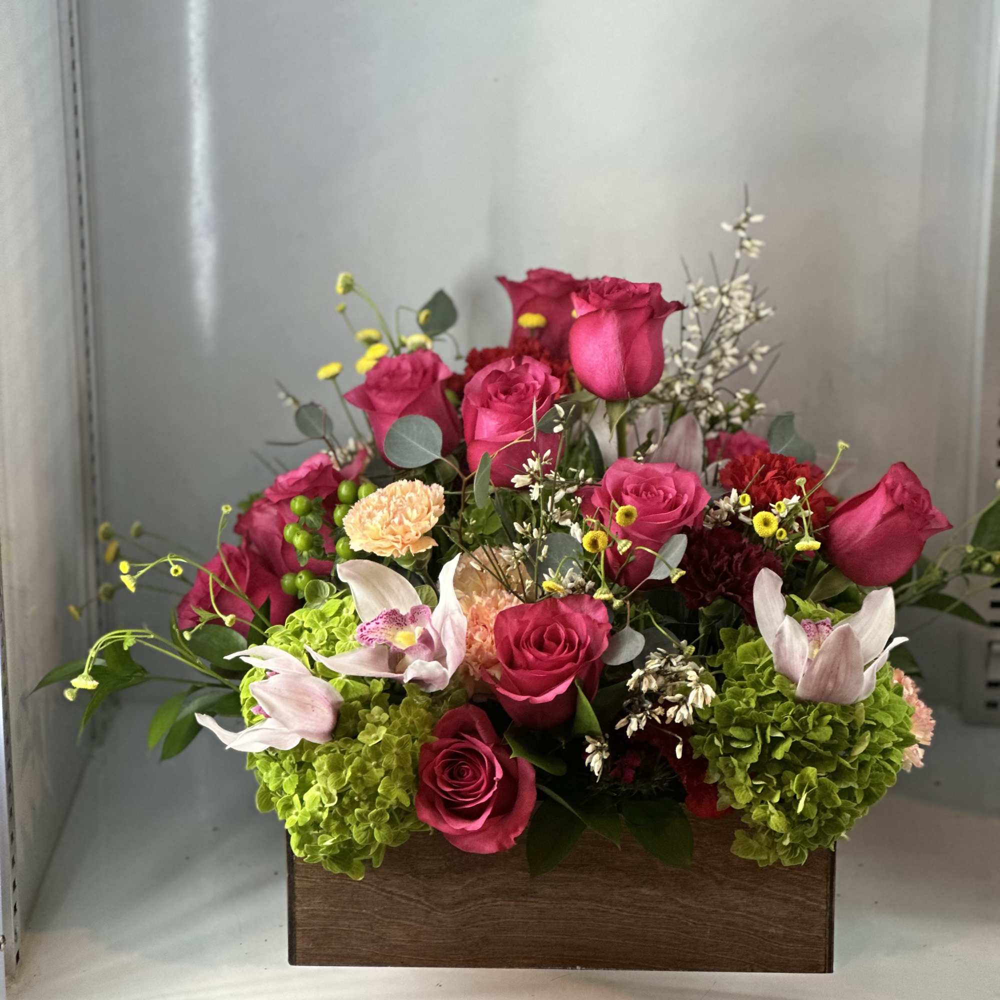 Hydrangeas, hot pink roses , carnations, and beautiful fillers , bring life