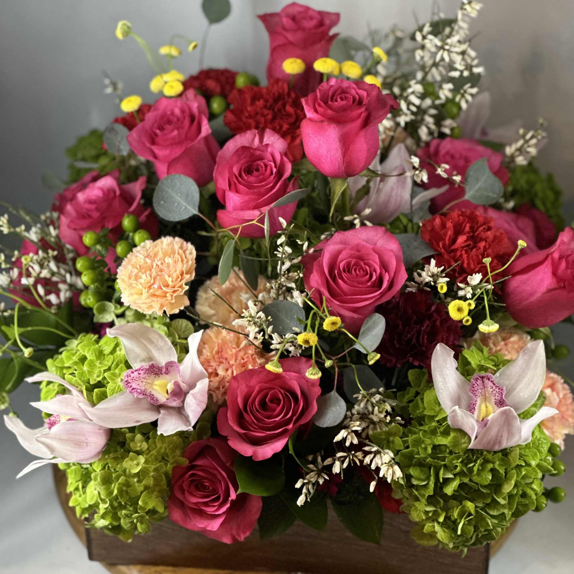 Hydrangeas, hot pink roses , carnations, and beautiful fillers , bring life