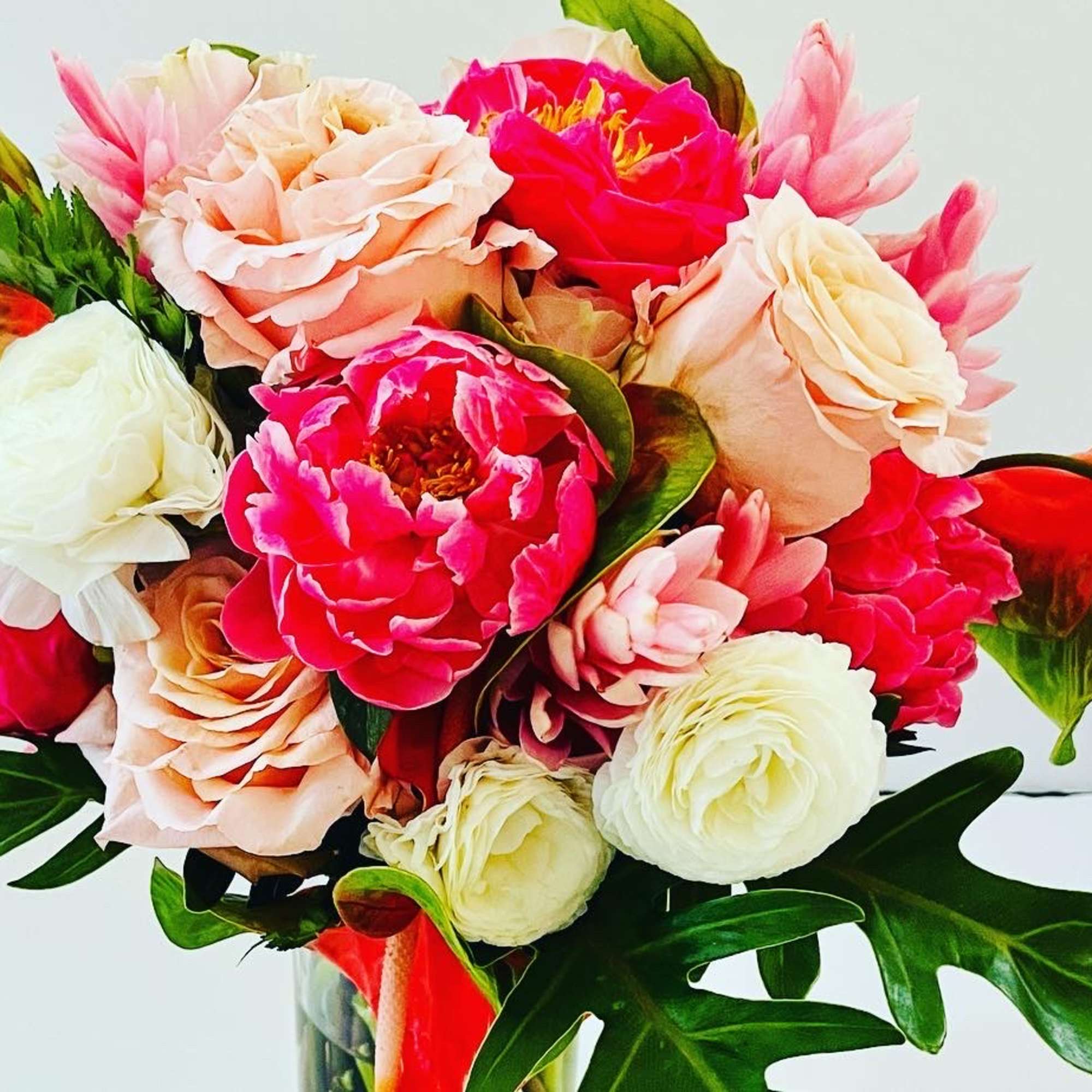 A combination of seasonal garden and tropical blooms selected by color scheme.