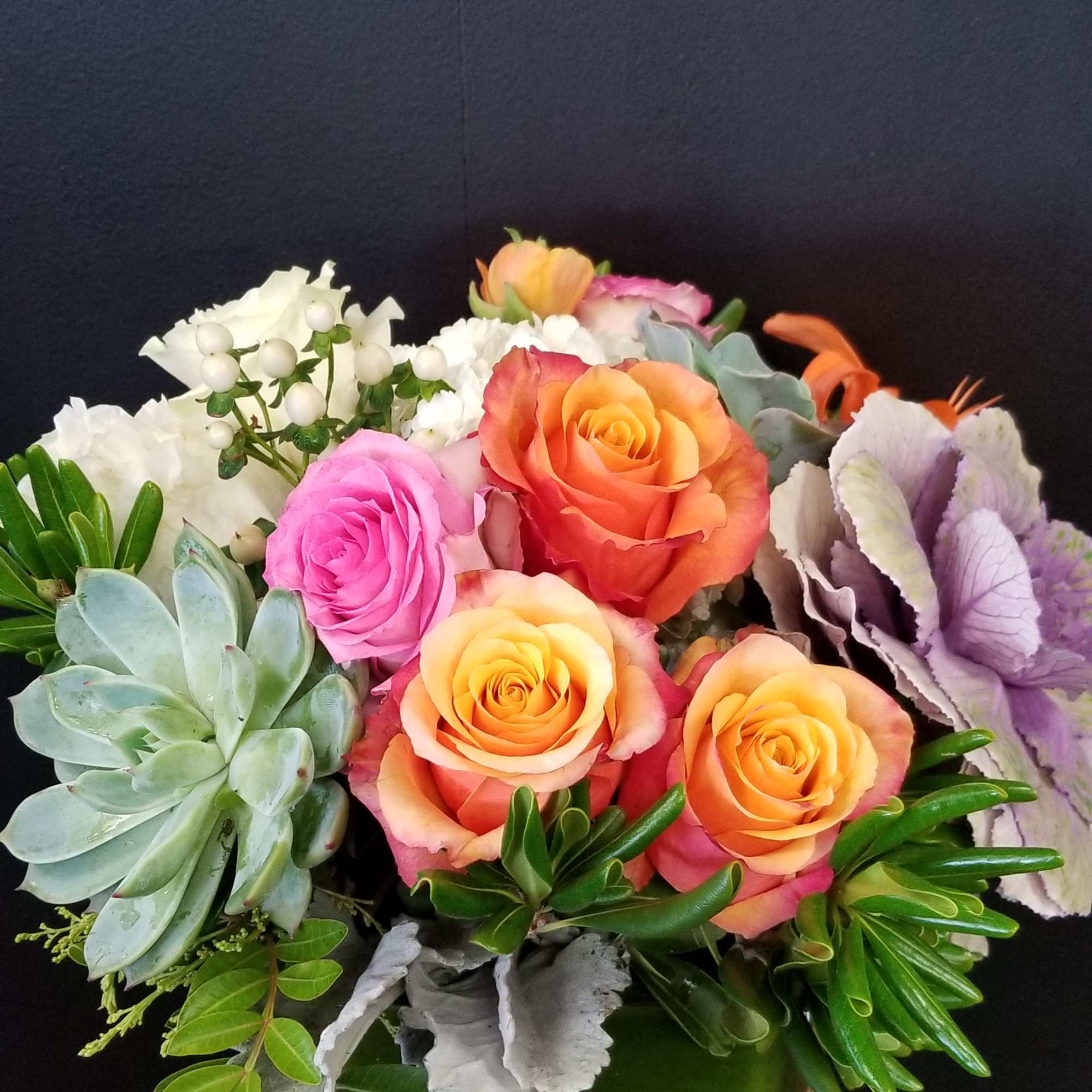 Assorted color of Rose arrangement with succulents in a cube vase
