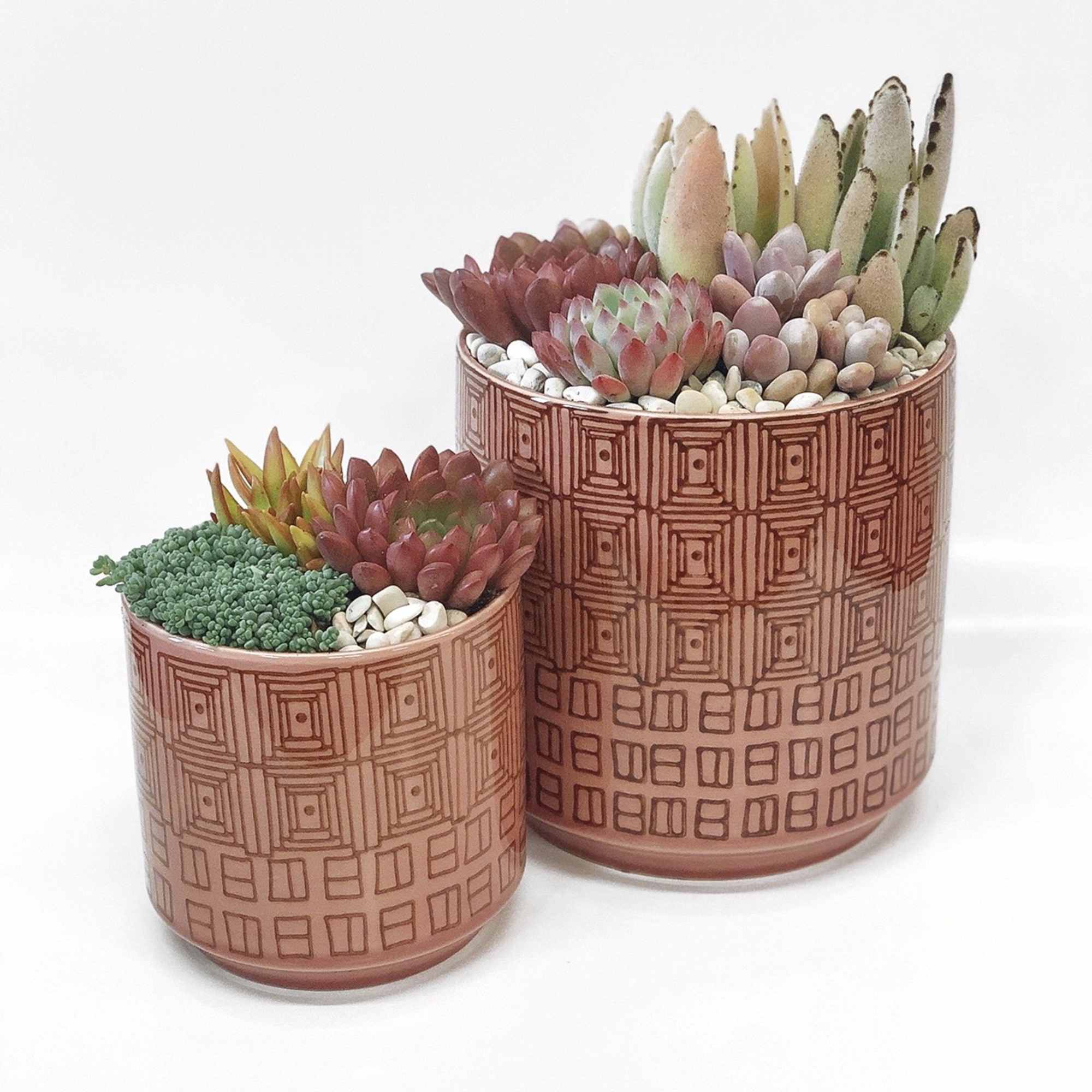 This is a red colored set of pots with a pattern printed This is a red colored set of pots with a pattern printed
