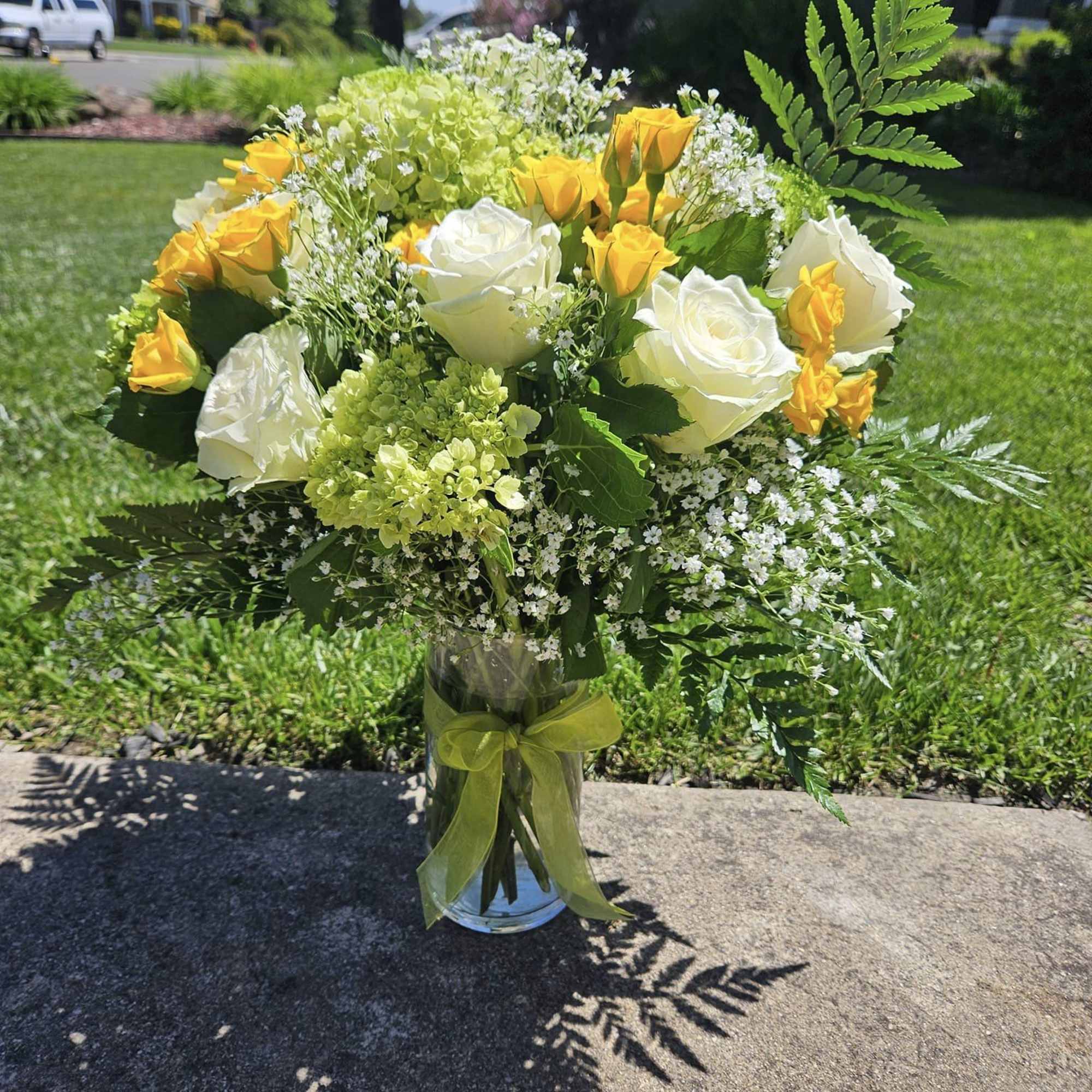 A mix of yellows and whites. A dozen roses with spray roses
