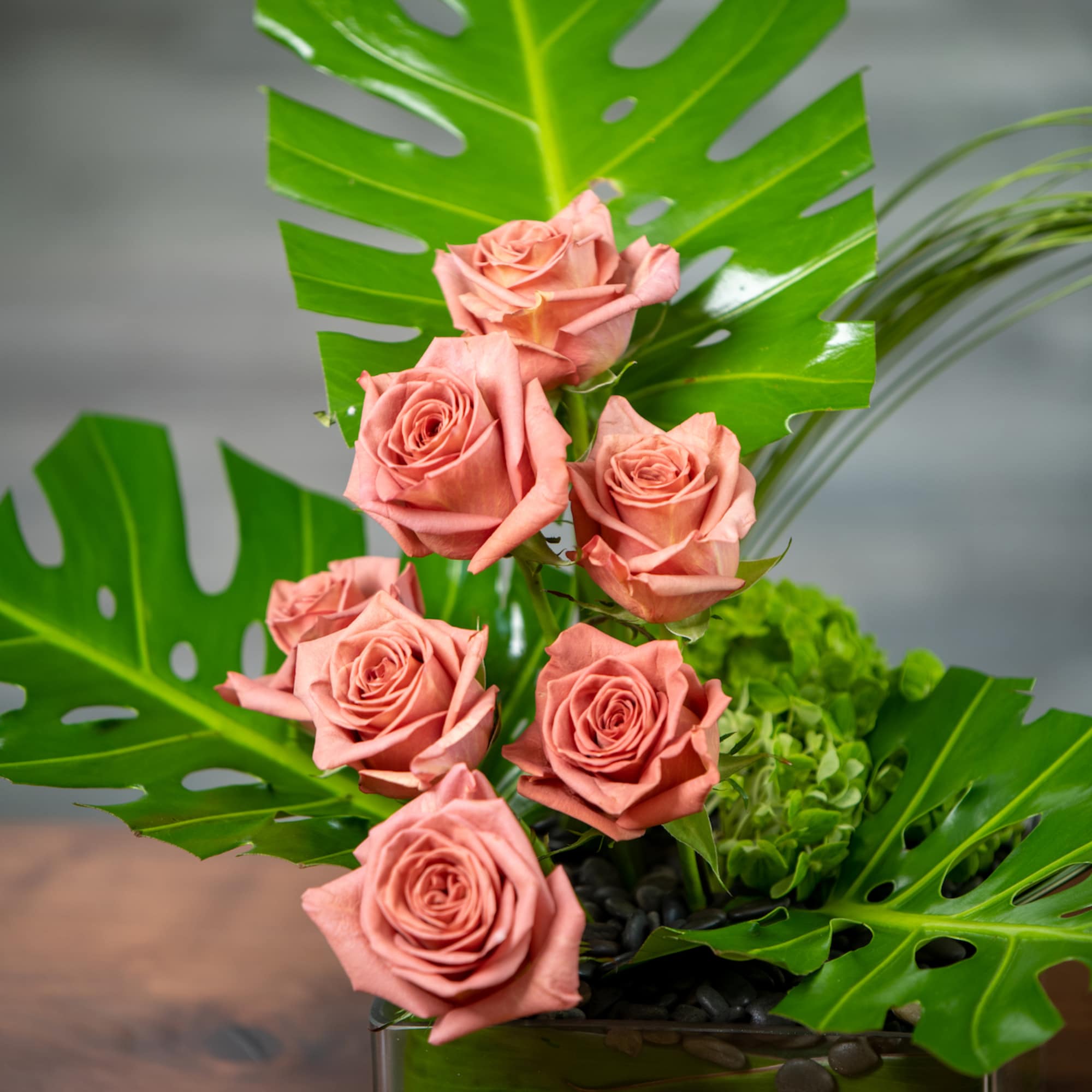 Minimalist and modern combination of terra cotta roses, looping grasses and tropical Minimalist and modern combination of terra cotta roses, looping grasses and tropical