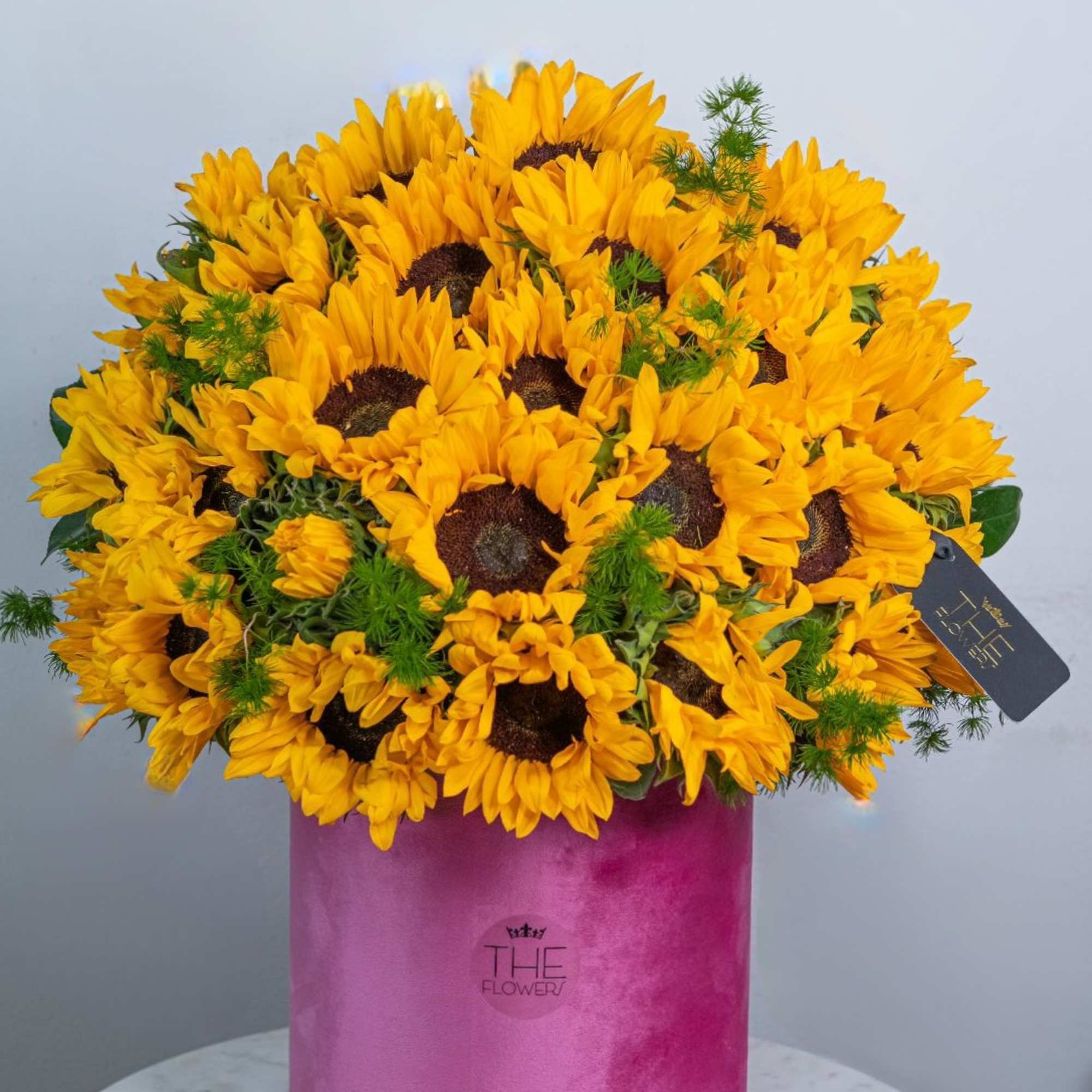 The solar composition in the box looks attractive! A bouquet of sunflowers