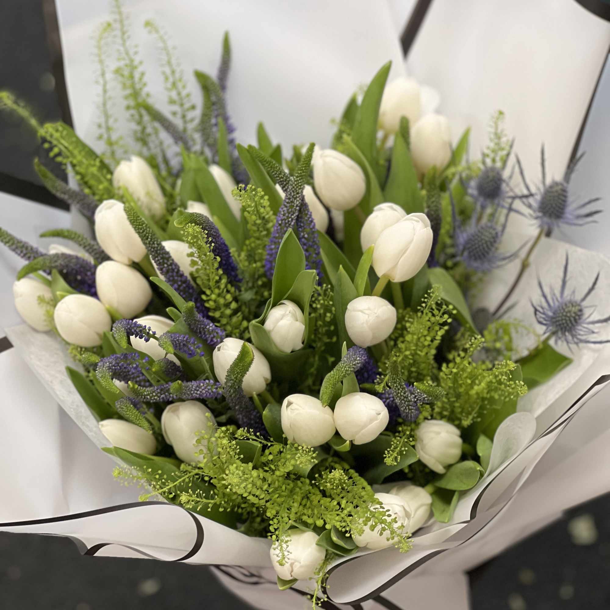 Mixture of a spring, tulips and supporting filler flowers wrapped bouquet 
Please