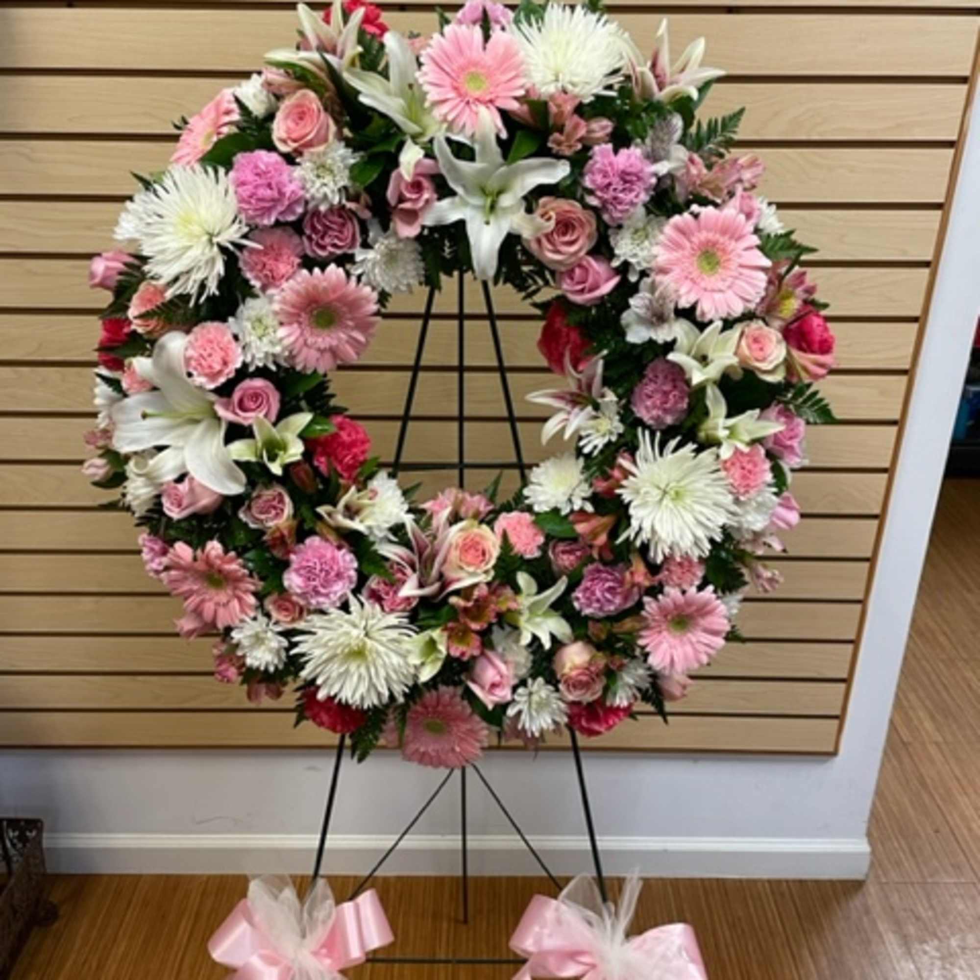 Mixed cut flower wreath. With a mixture of pink roses, pink carnation Mixed cut flower wreath. With a mixture of pink roses, pink carnation
