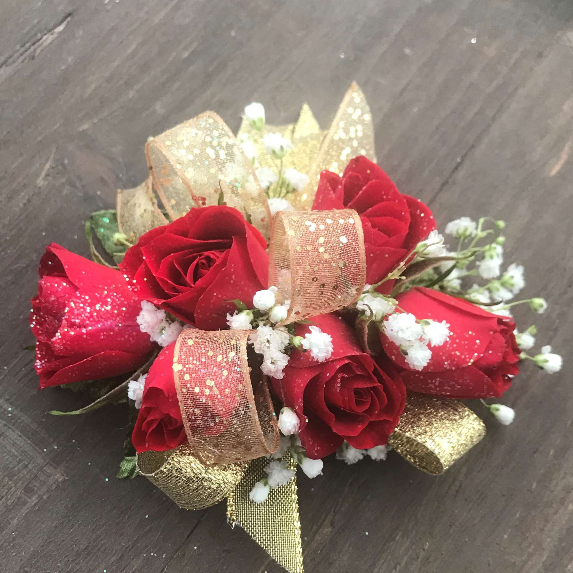 Red Spray Roses with gold accents designed on wrist band.