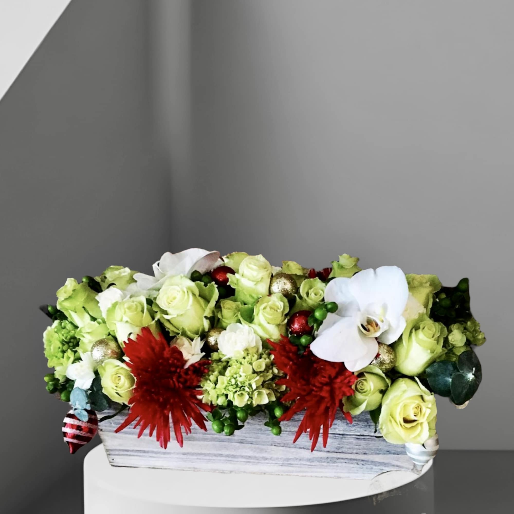 A festive addition to your holiday table. An arrangement of holiday colored