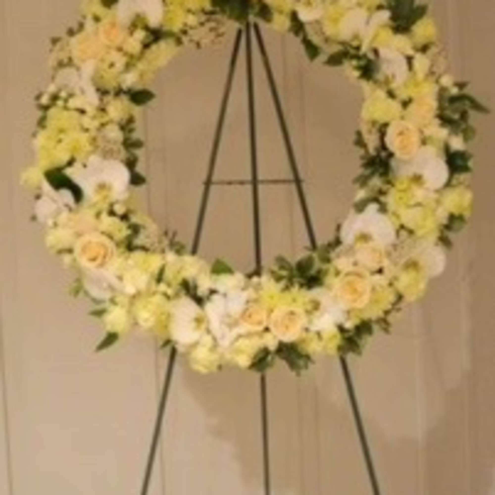 A 22&quot; diameter wreath of roses, orchids, and seasonal white flowers with