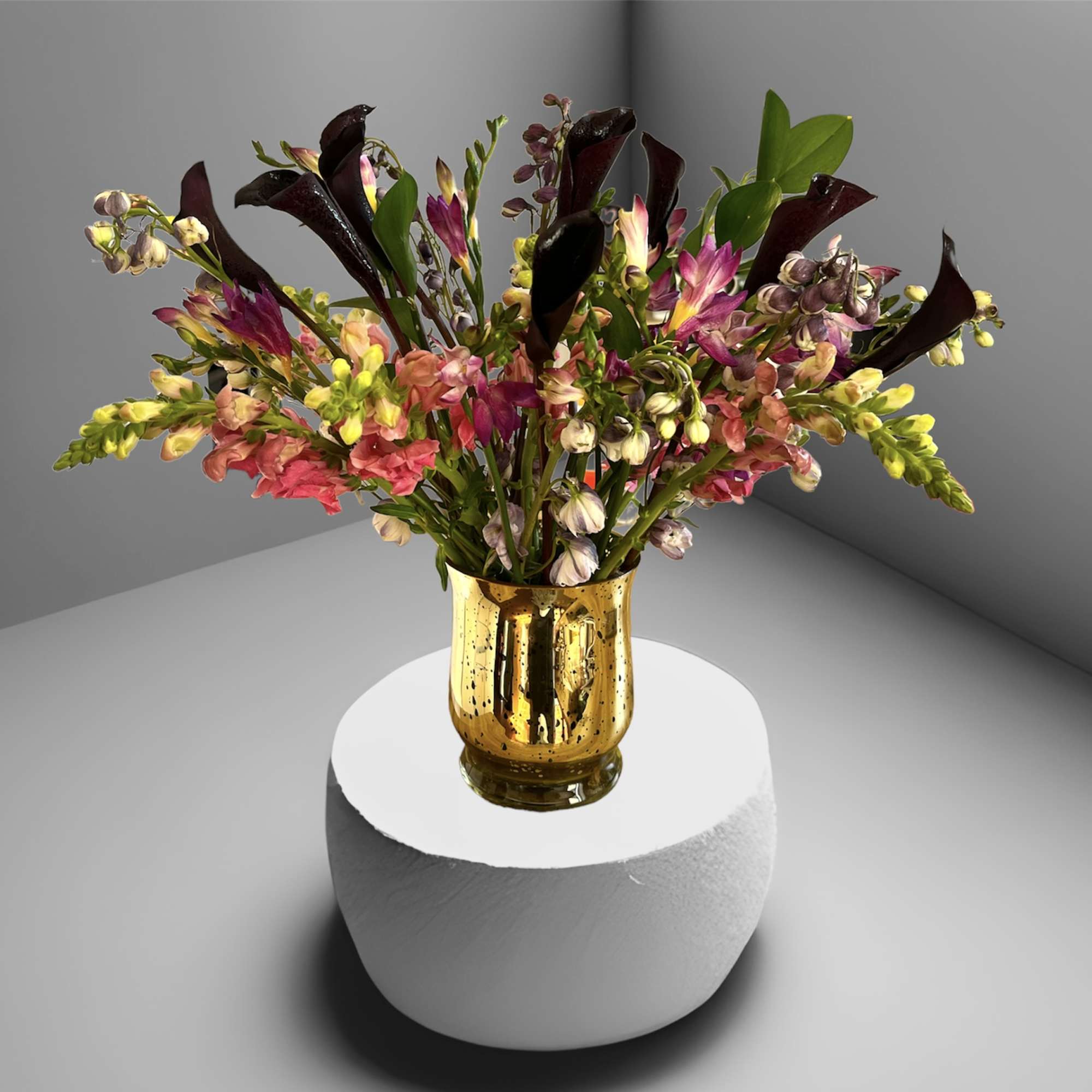 A stunning mix of calla lilies, snap dragon, delphinium, freesia and foliage