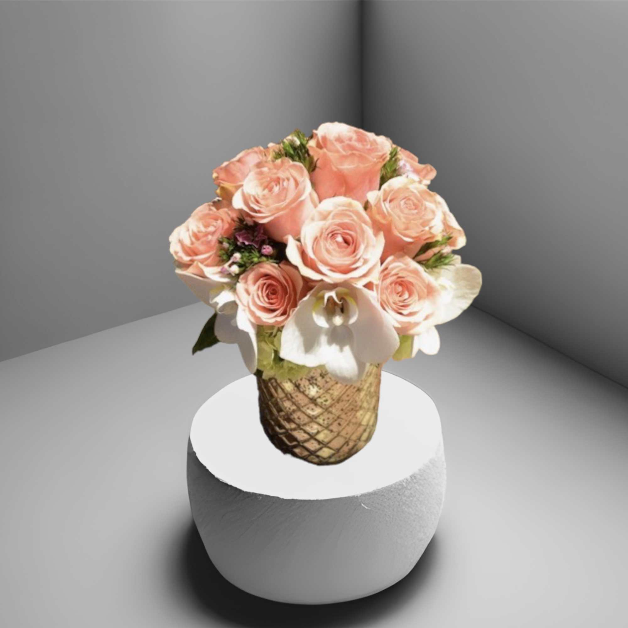 One dozen pink roses surrounded by orchids, hydrangea, and foliage. This pretty