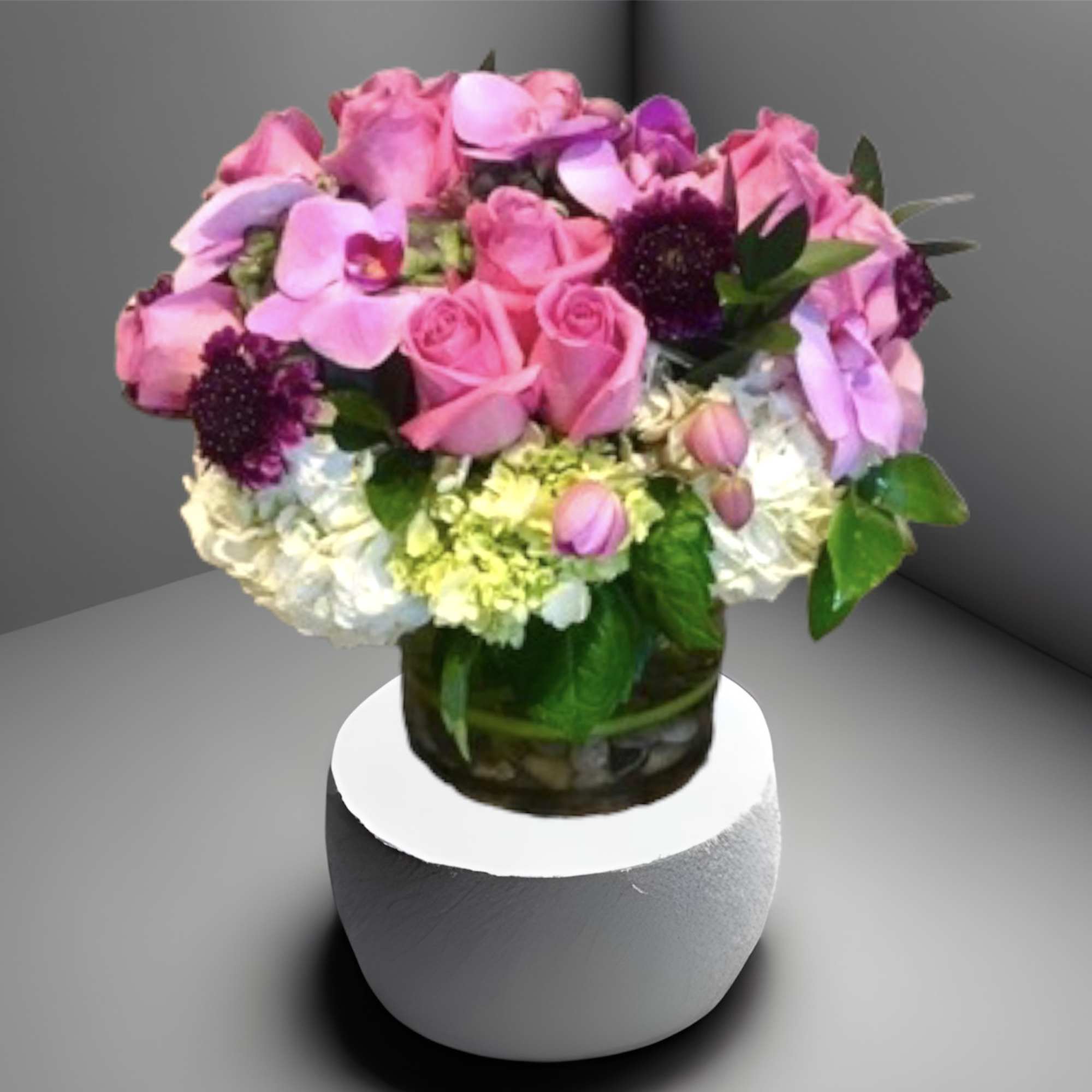 A lovely mix of pinks and purples with roses, orchids, hydrangea and