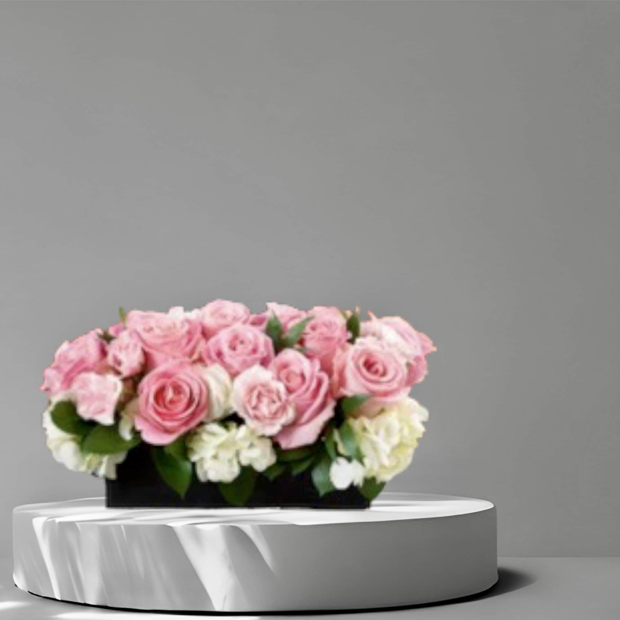 Pink Roses and Hydrangeas in a low rectangular vase.