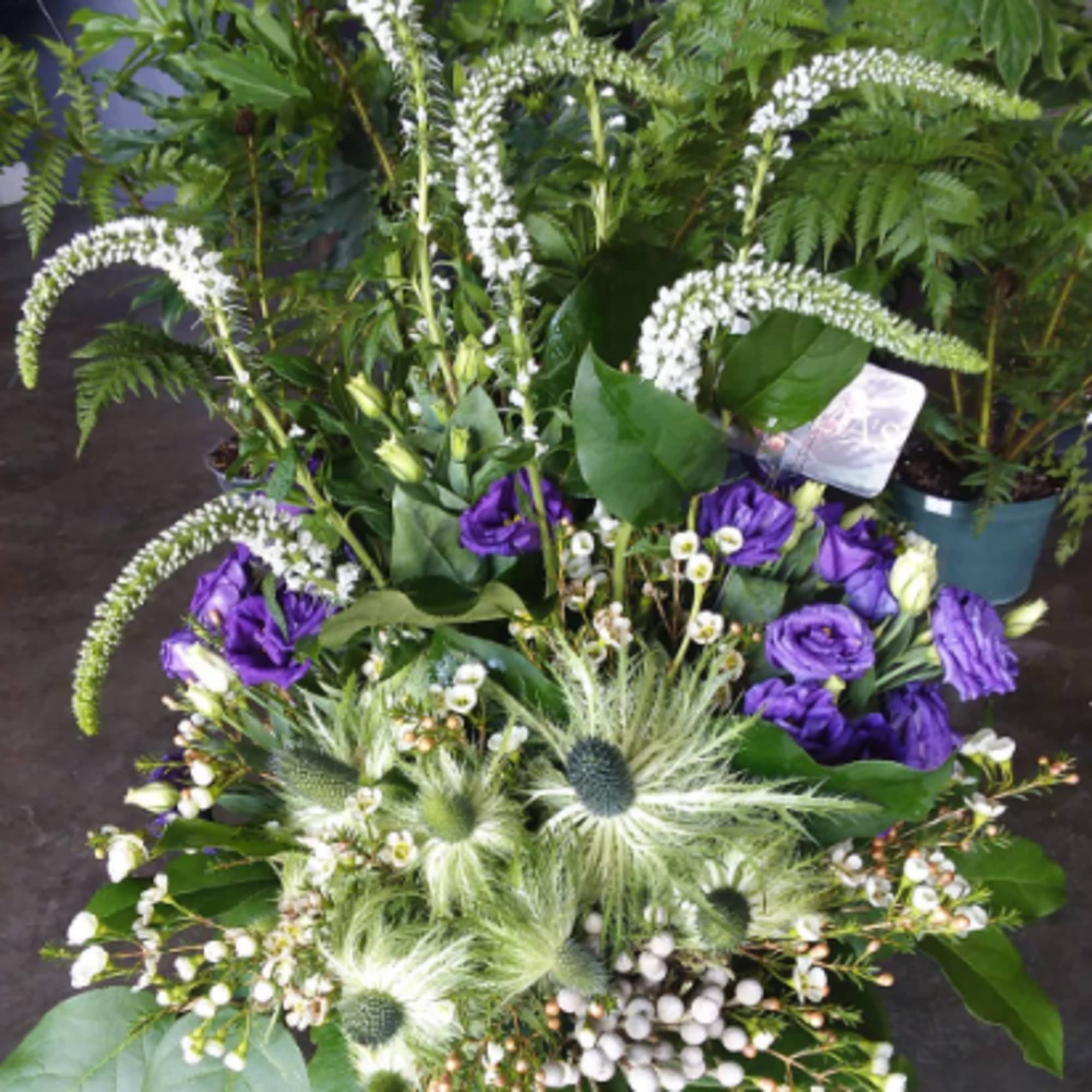 Using thistle and native blooms, this design can be customized to fill