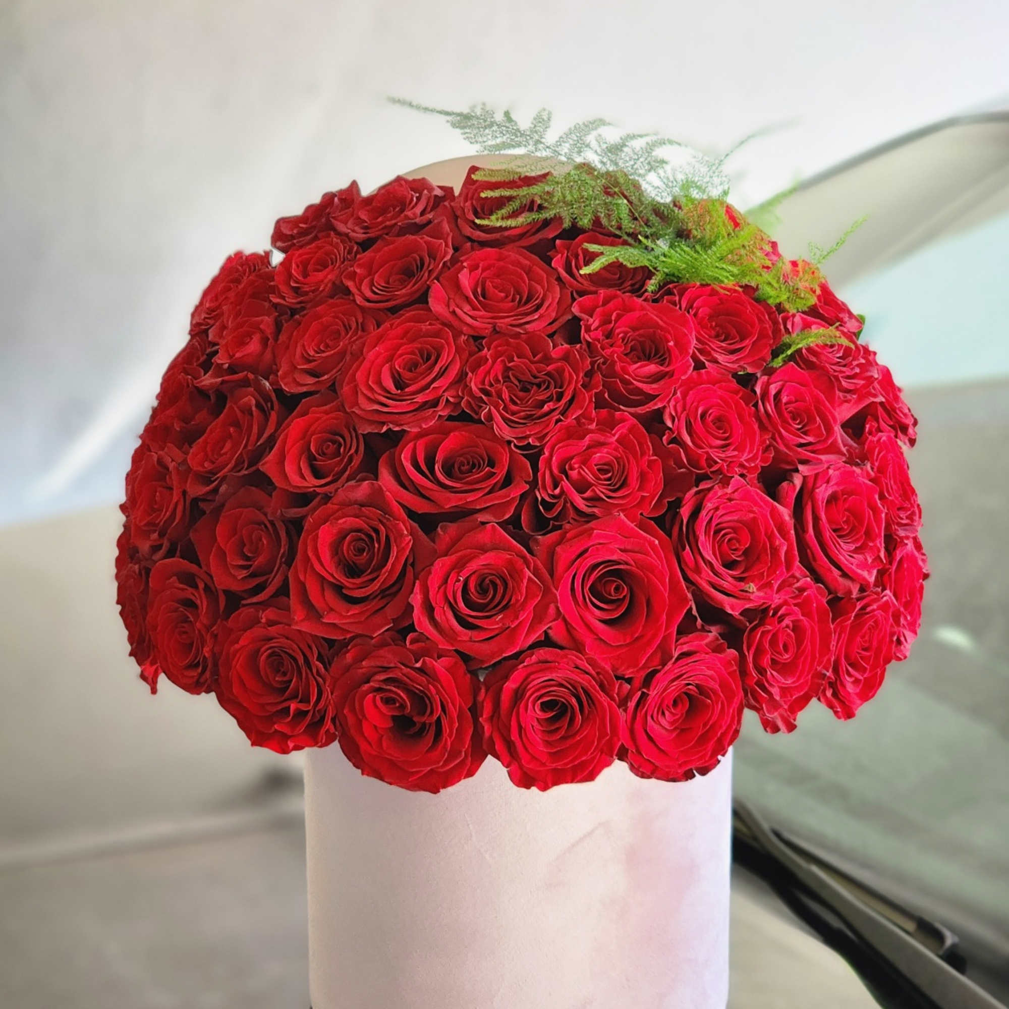 A floral arrangement of 50 red roses typically signifies deep love, passion