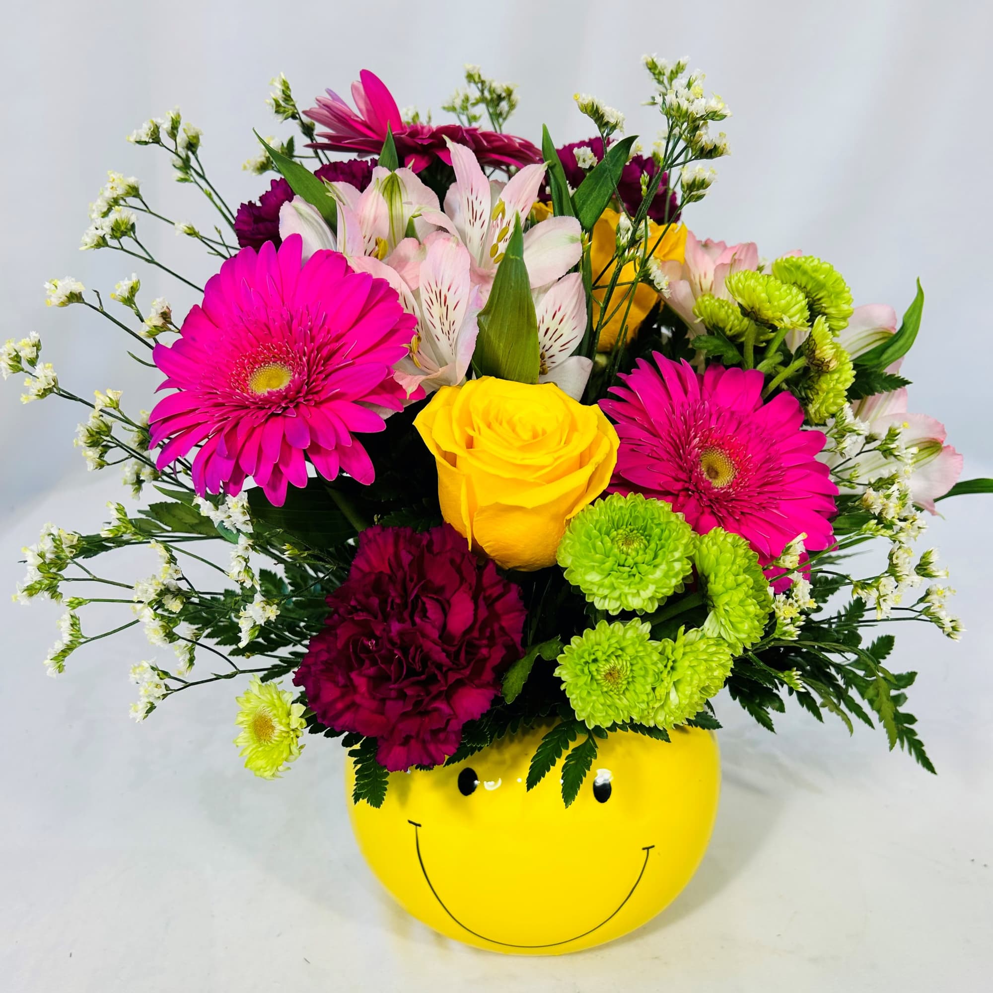 Send a smiley face arrangement to bright up someone's day. This smiley Send a smiley face arrangement to bright up someone's day. This smiley