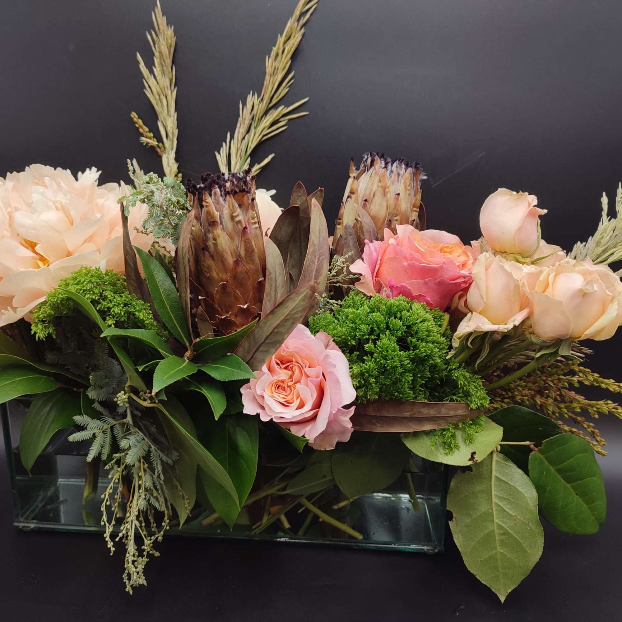 The bouquet pictured reflects our original design for this product. While we