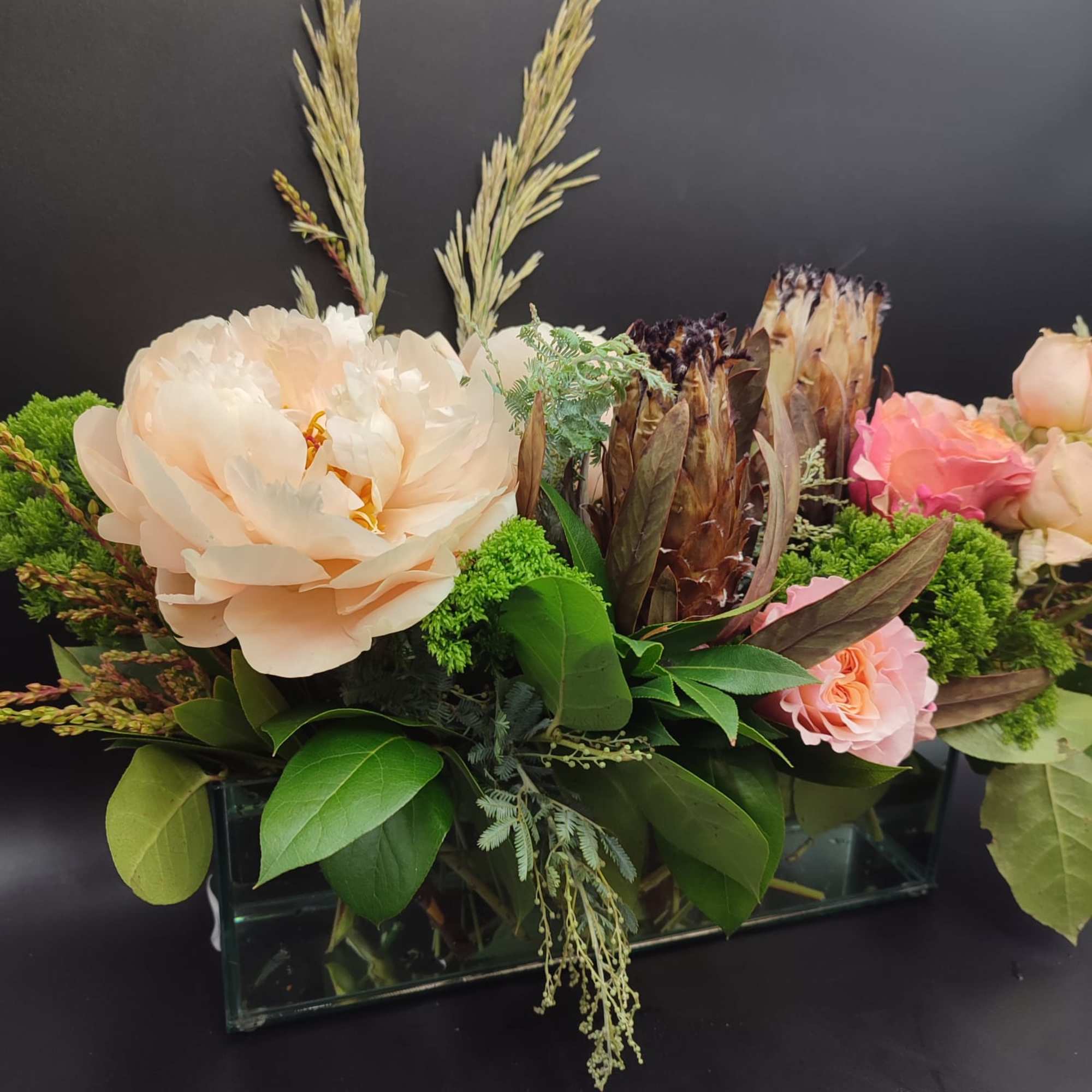 The bouquet pictured reflects our original design for this product. While we