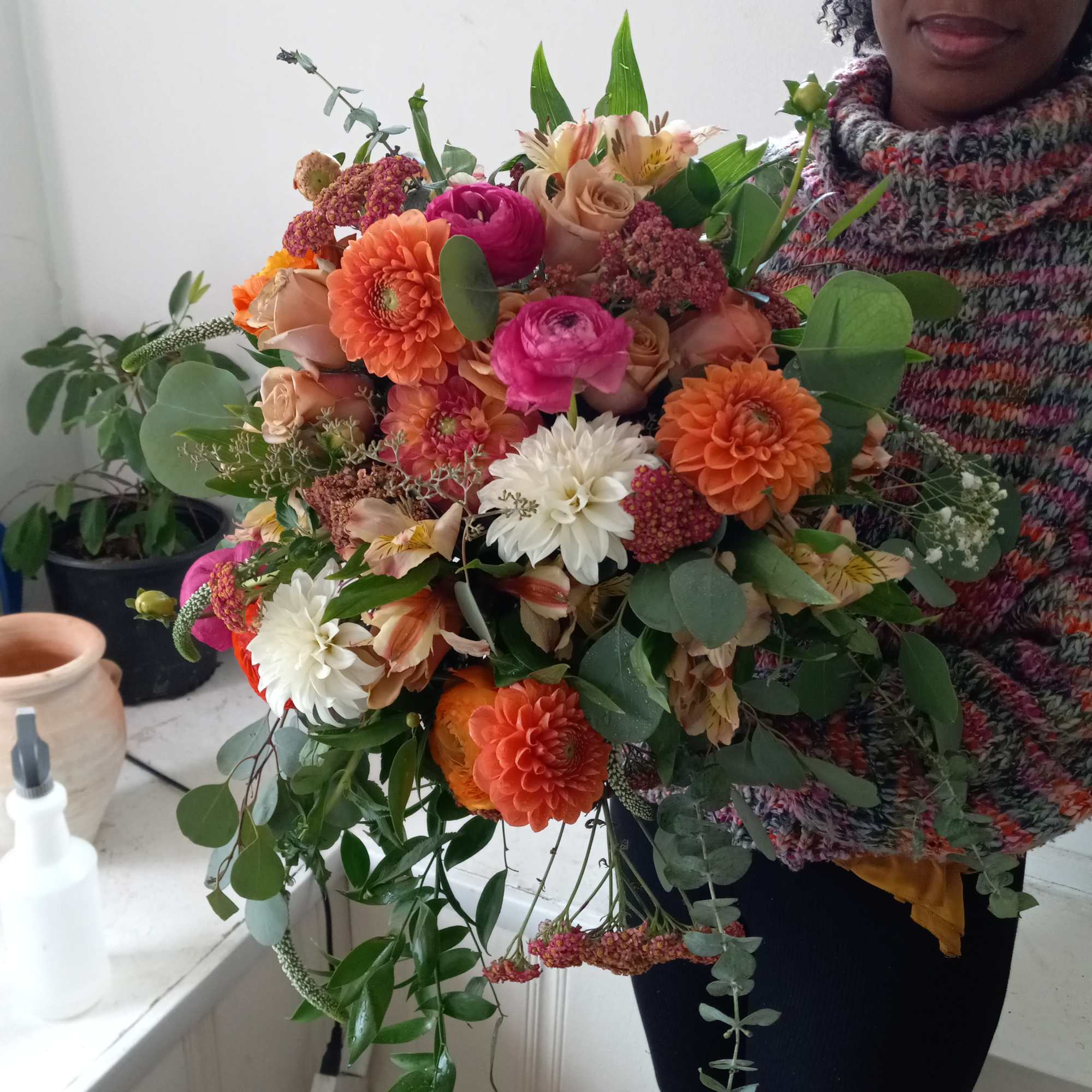 Rich and vibrant fall colors orange/terracotta dahlia, brown roses and similar color