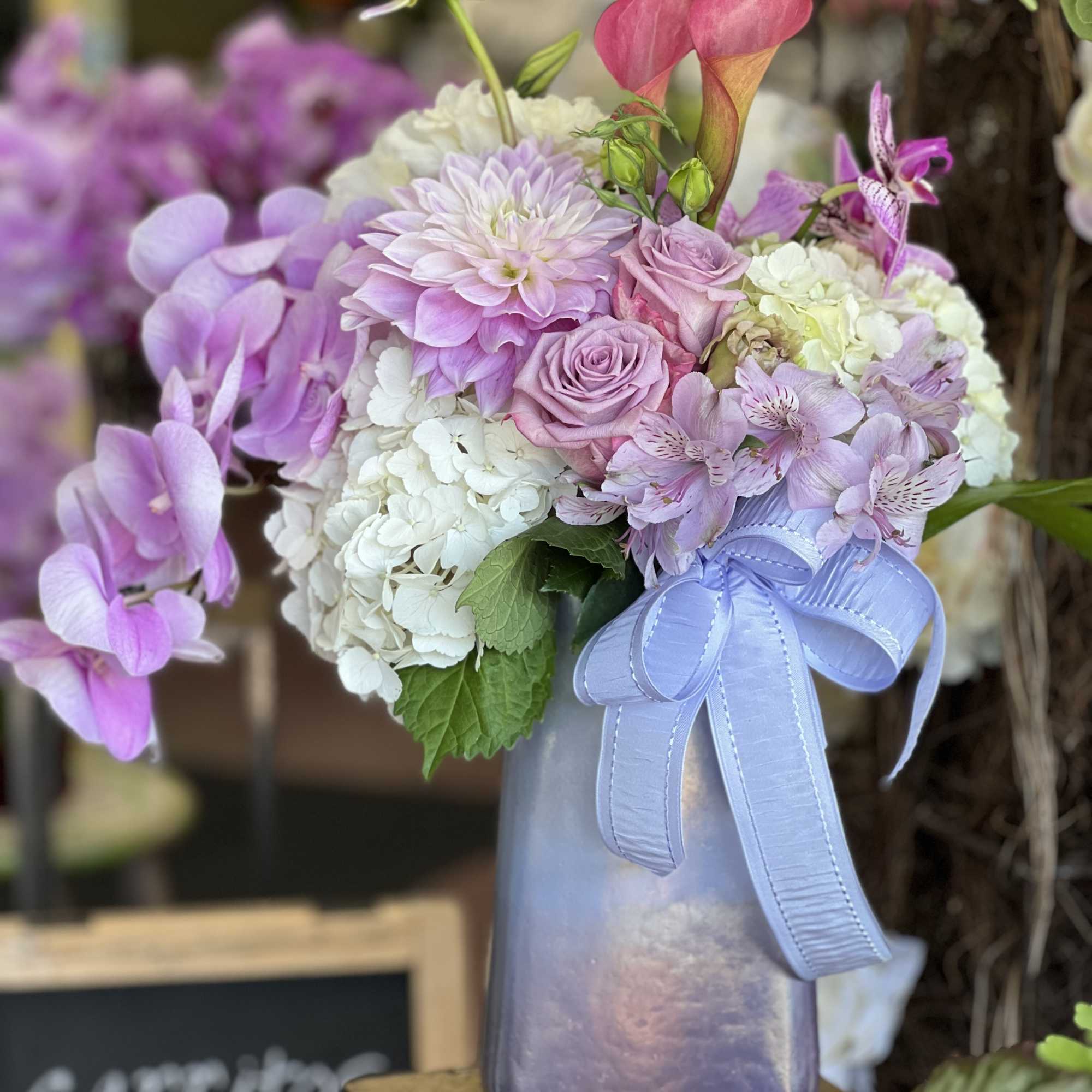Purple lavender silver mixed bouquet in the clear vase