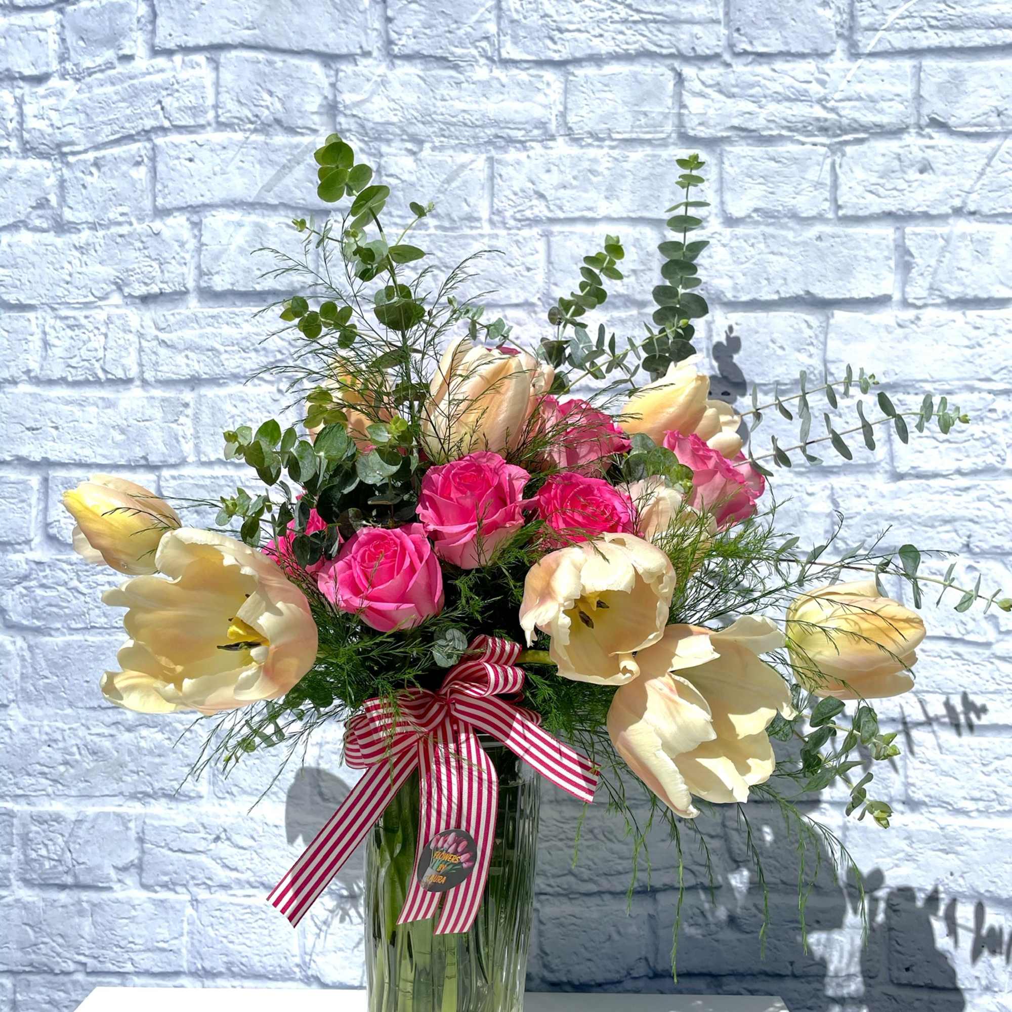 An assortment of fresh flowers in a large vase.