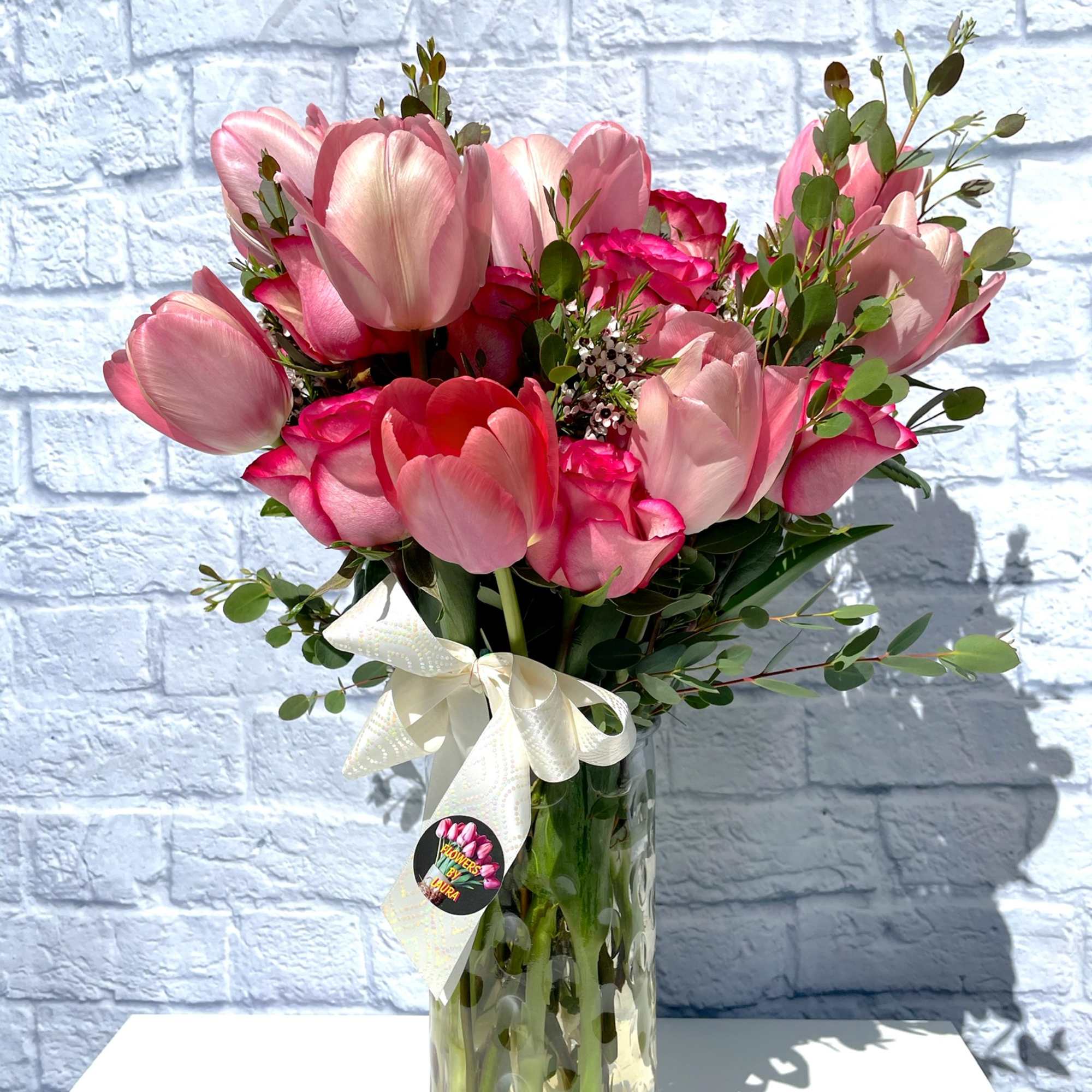 An assortment of fresh flowers in a large vase.