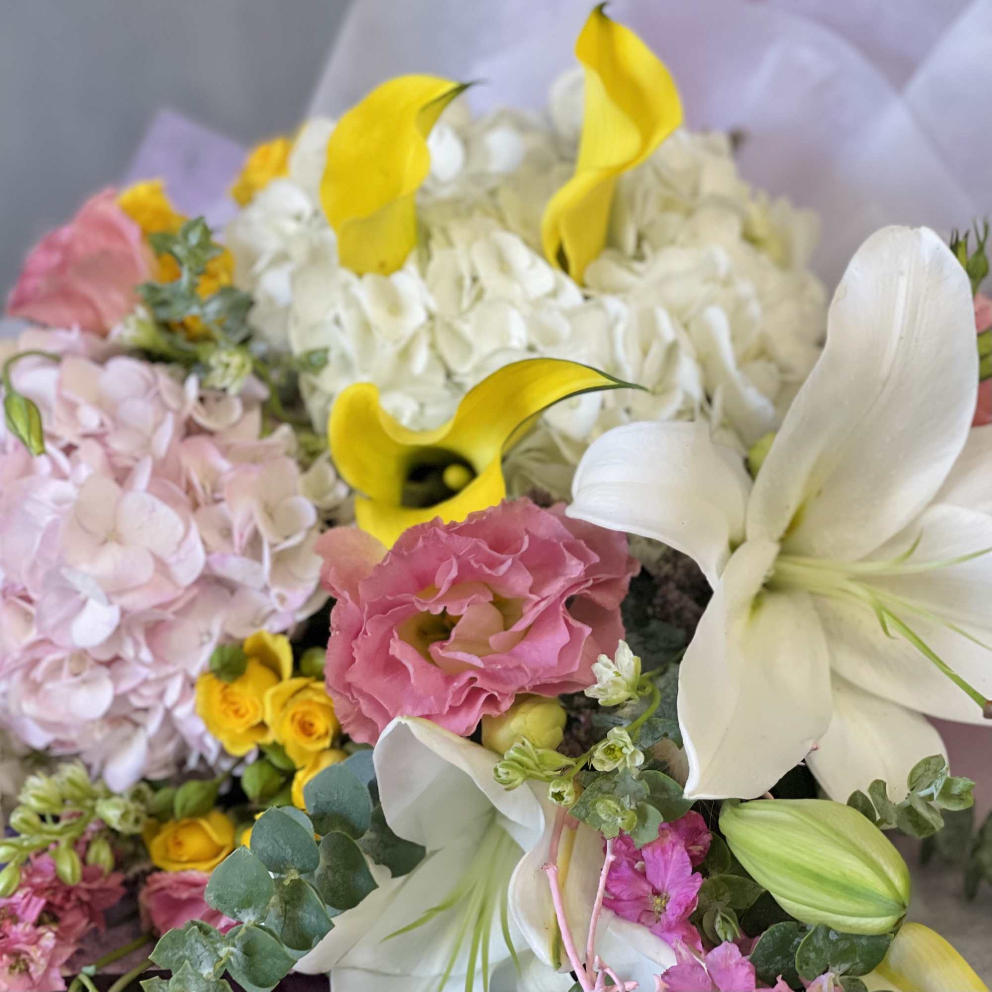 A beautiful mixed Bouquet with Lilies, Hydrangeas, Eucalyptus and various seasonal blooms.