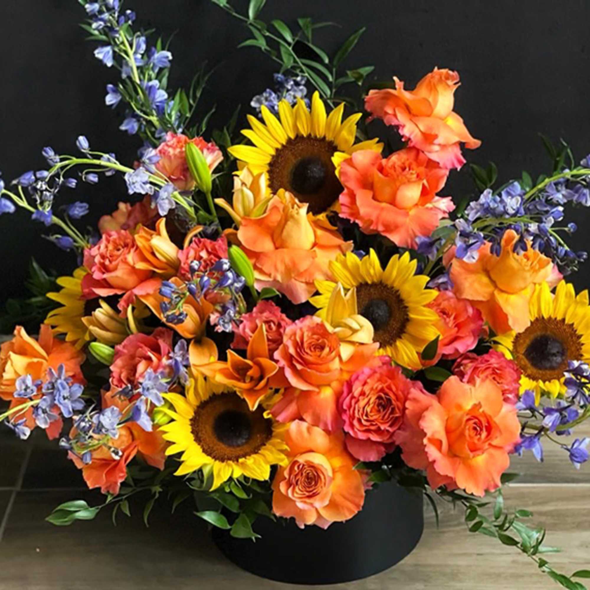 Sunflowers, Roses, Italian Butcher&rsquo;s Broom, Lilies, Purple Delphinium, Black Box