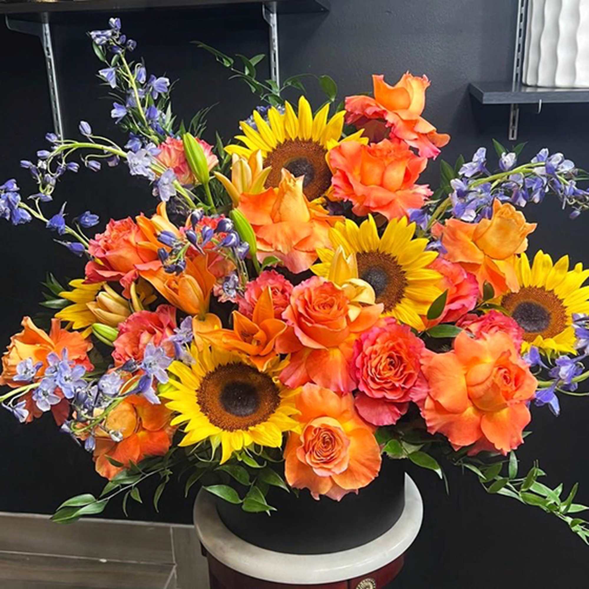 Sunflowers, Roses, Italian Butcher&rsquo;s Broom, Lilies, Purple Delphinium, Black Box