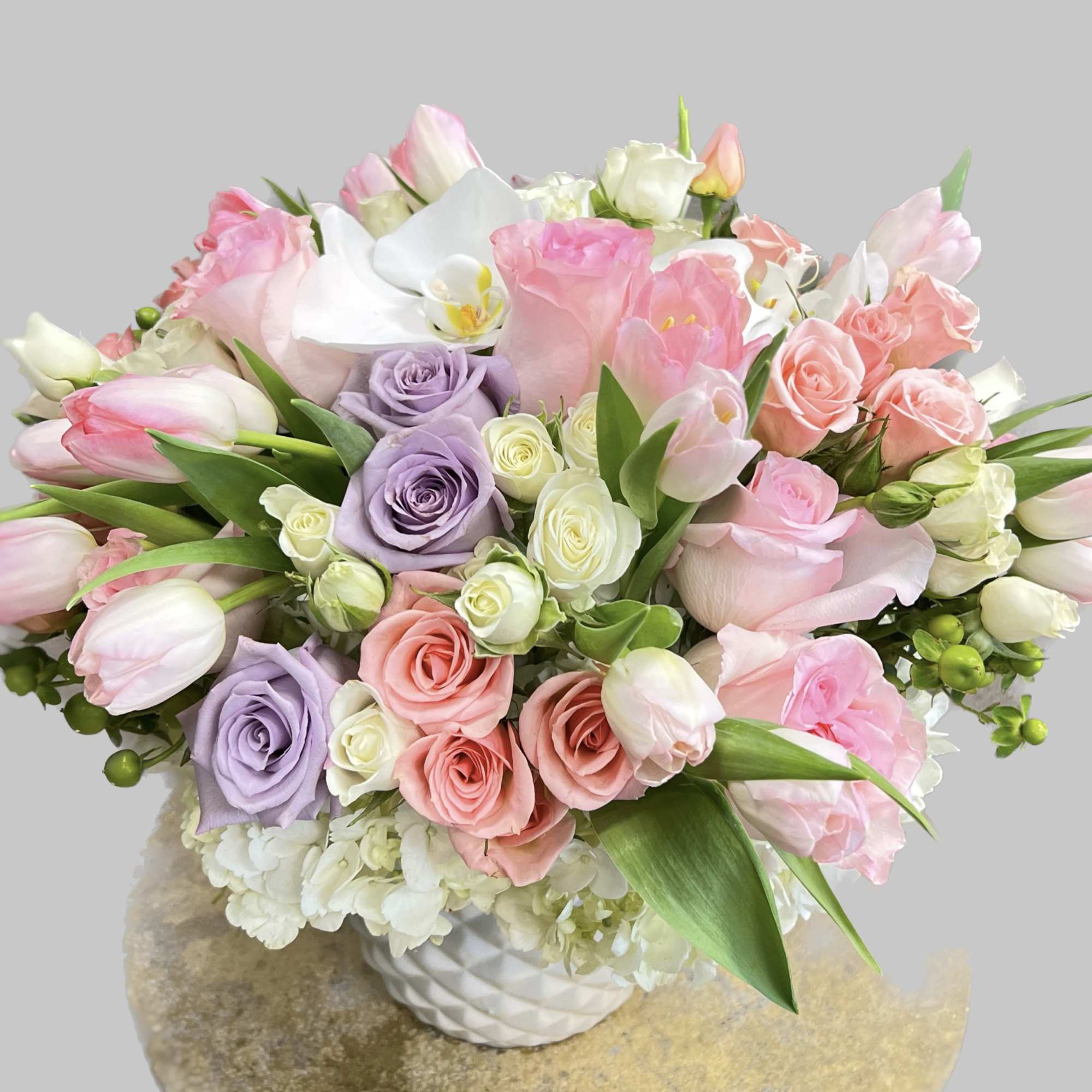 Captivating arrangement filled with mixed shades of pink  lavender roses, pink
