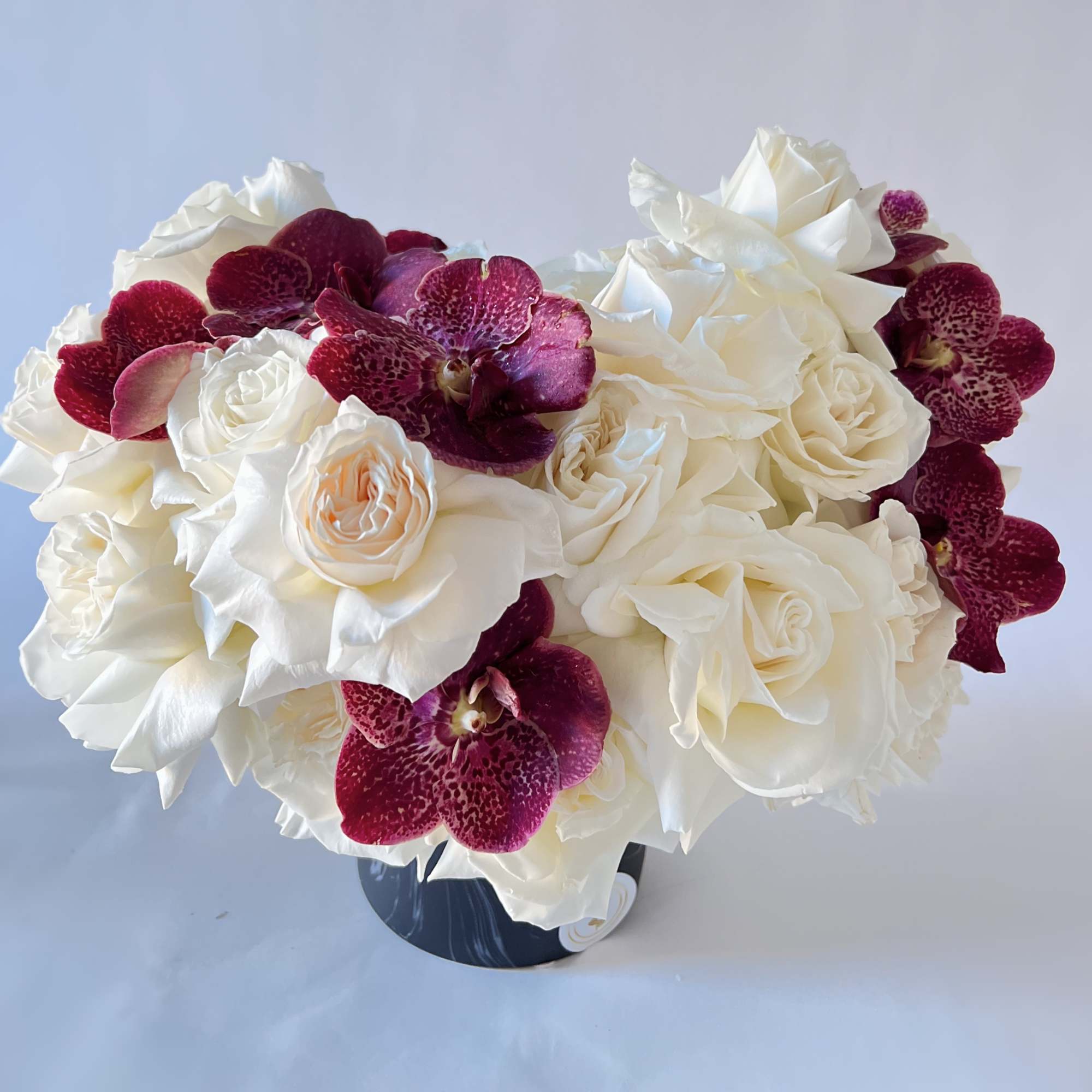 Elegant White roses , chocolate pink vanda orchids are with in the