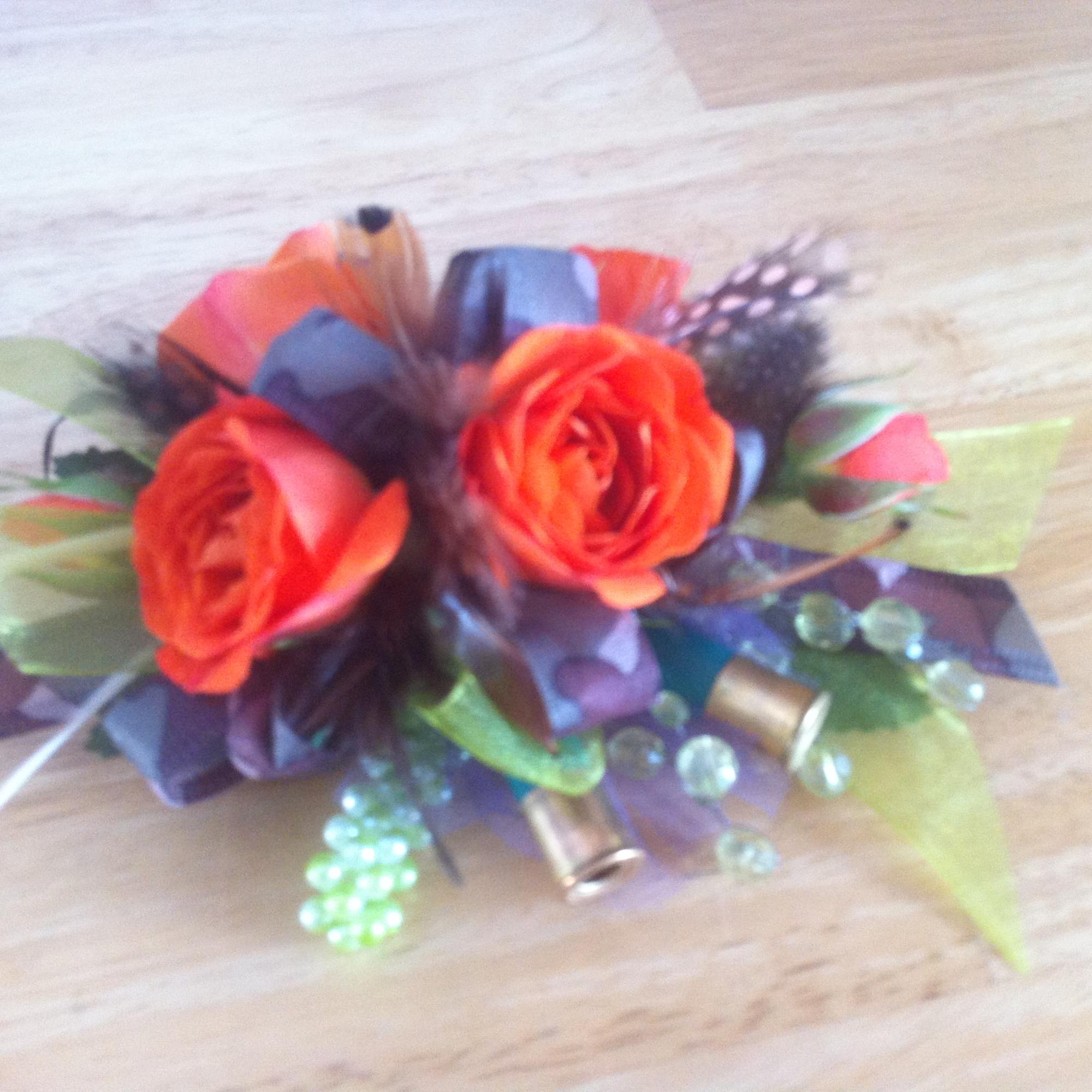 Orange Roses, Camo RIbbon, and Shot gun Shells are the perfect accessory