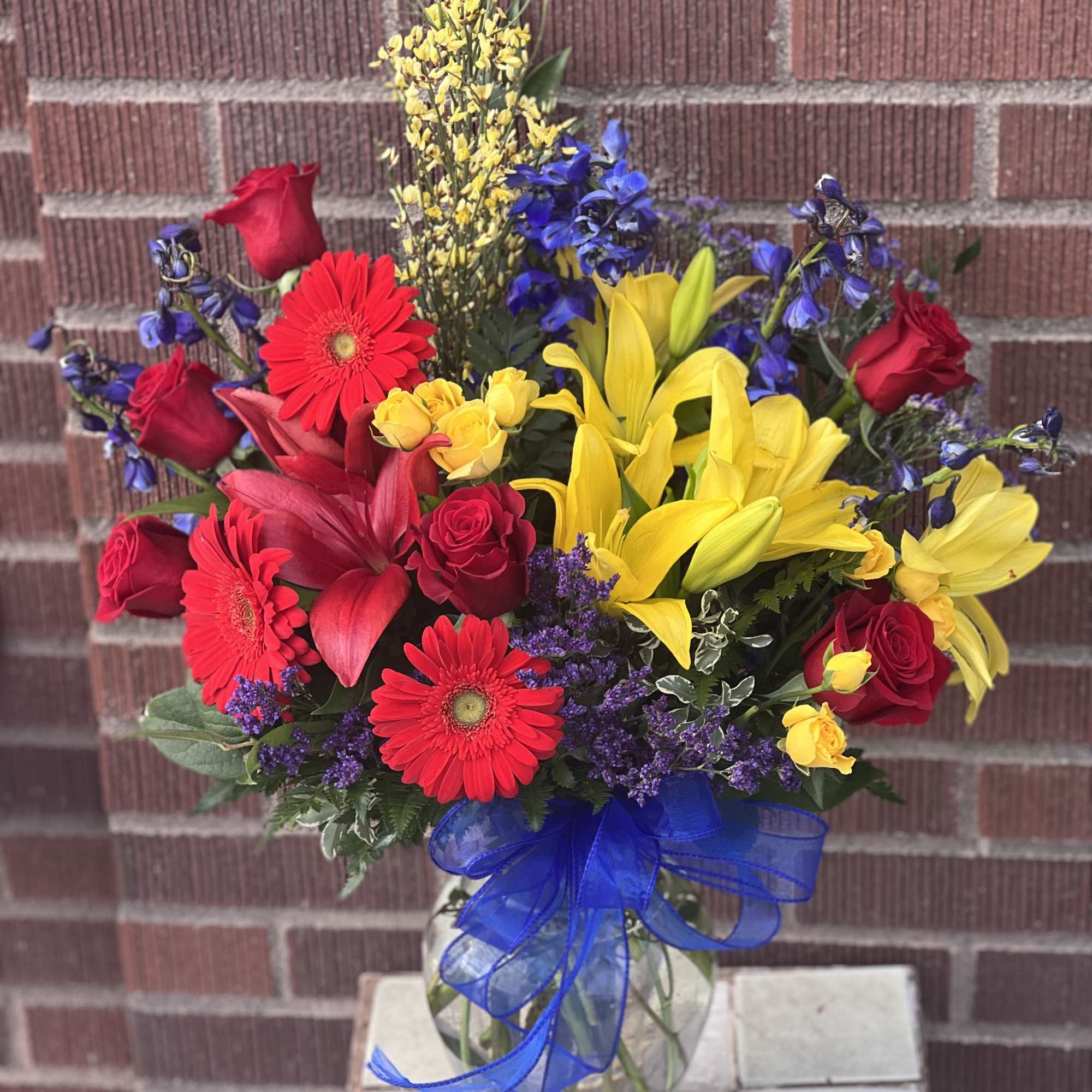 In a mix of primary colors, this bright arrangement designed by one In a mix of primary colors, this bright arrangement designed by one