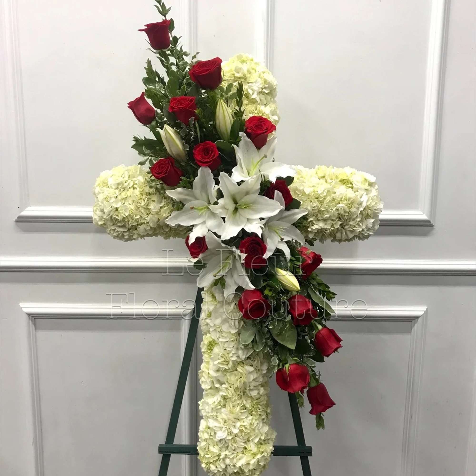 A cluster of Red Roses and White Lilies on a body of