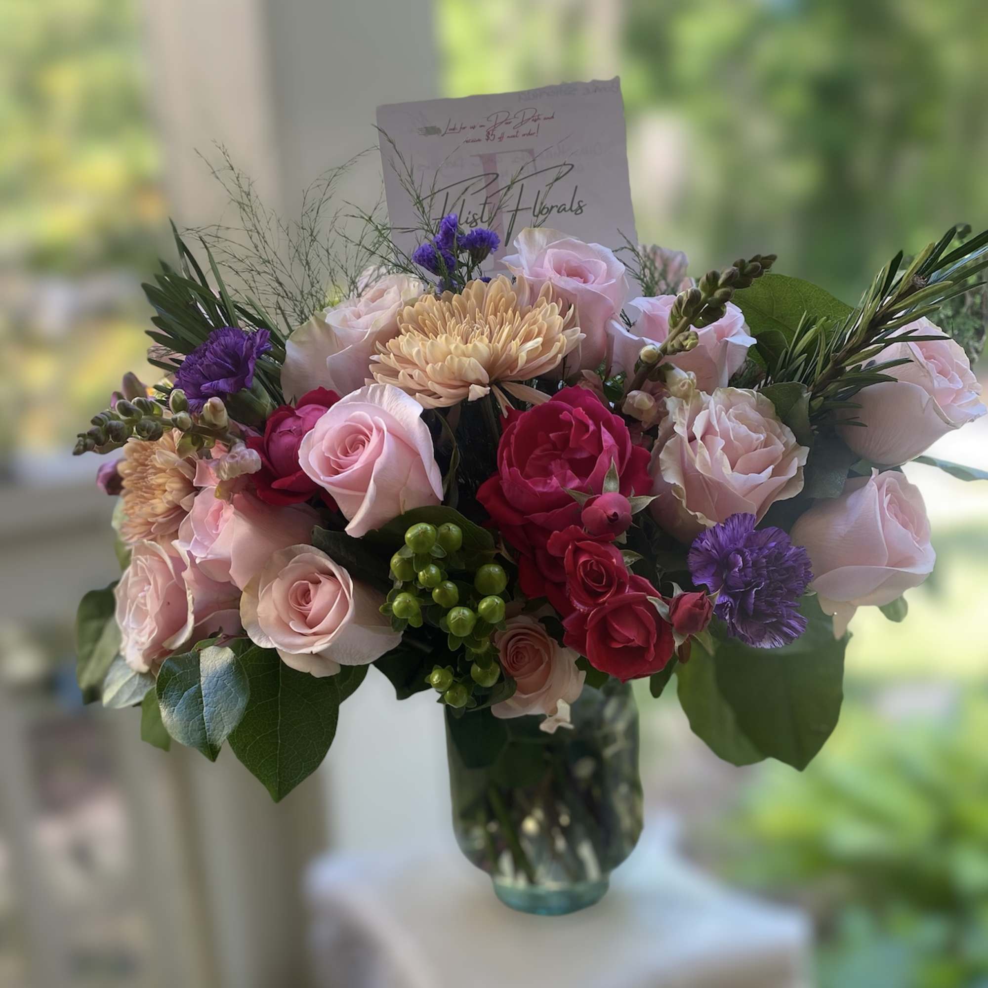 A luscious combination of roses Mums and seasonal fillers for the classic A luscious combination of roses Mums and seasonal fillers for the classic