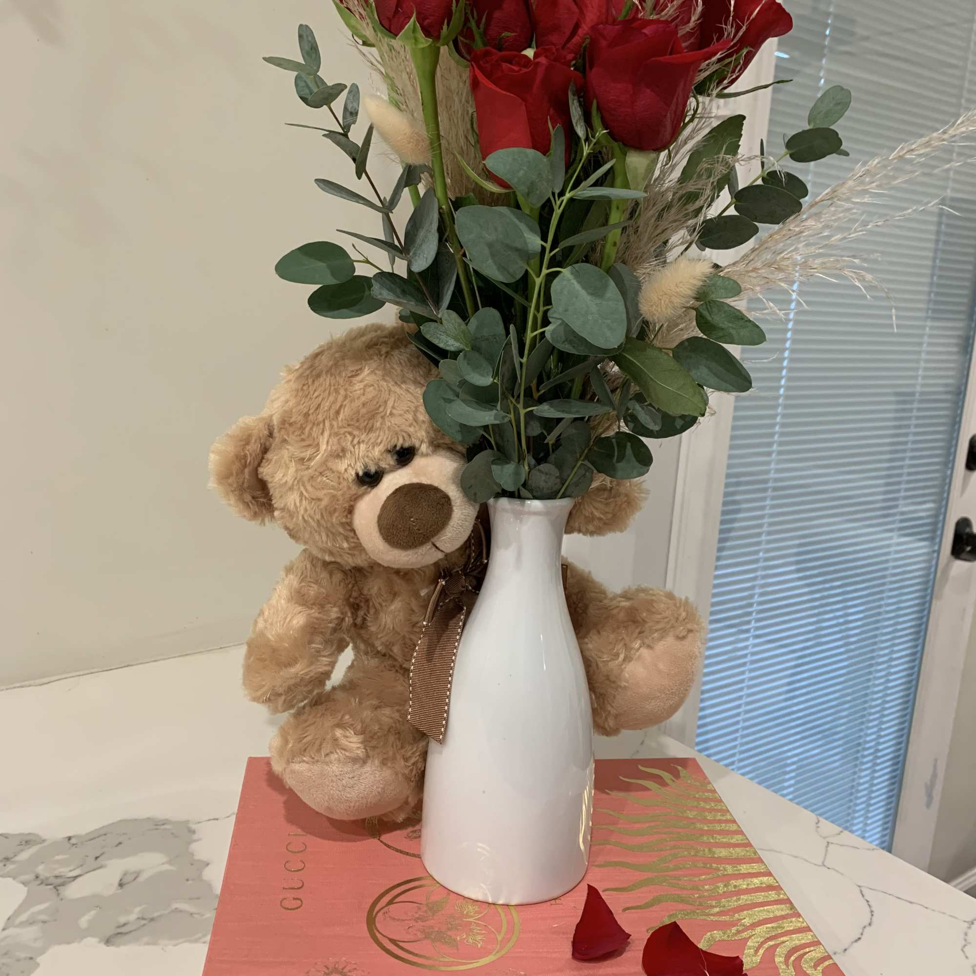 One dozen of red roses with a puffy friend and dry flowers