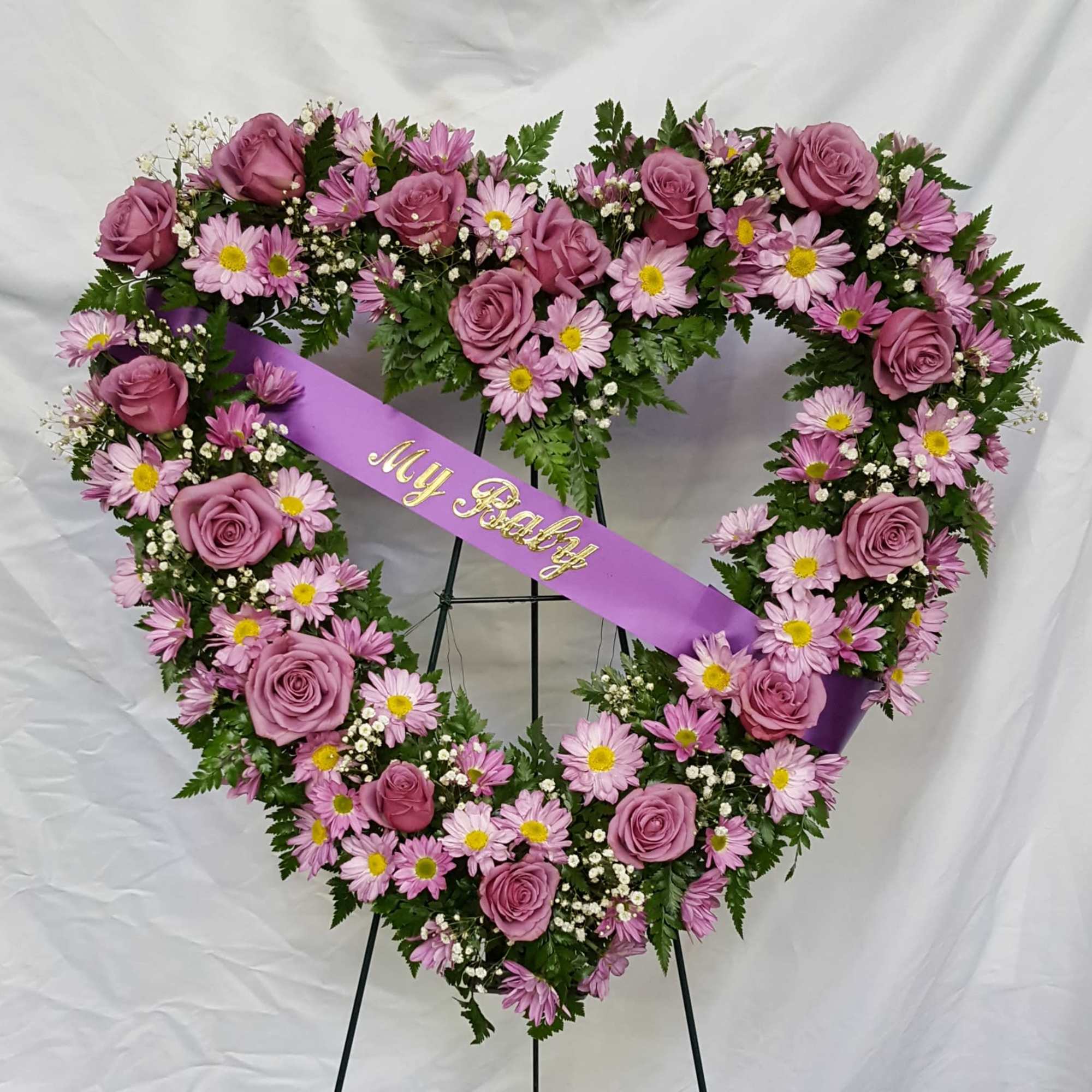 A touching tribute for lost loved one. An open heart wreath that A touching tribute for lost loved one. An open heart wreath that