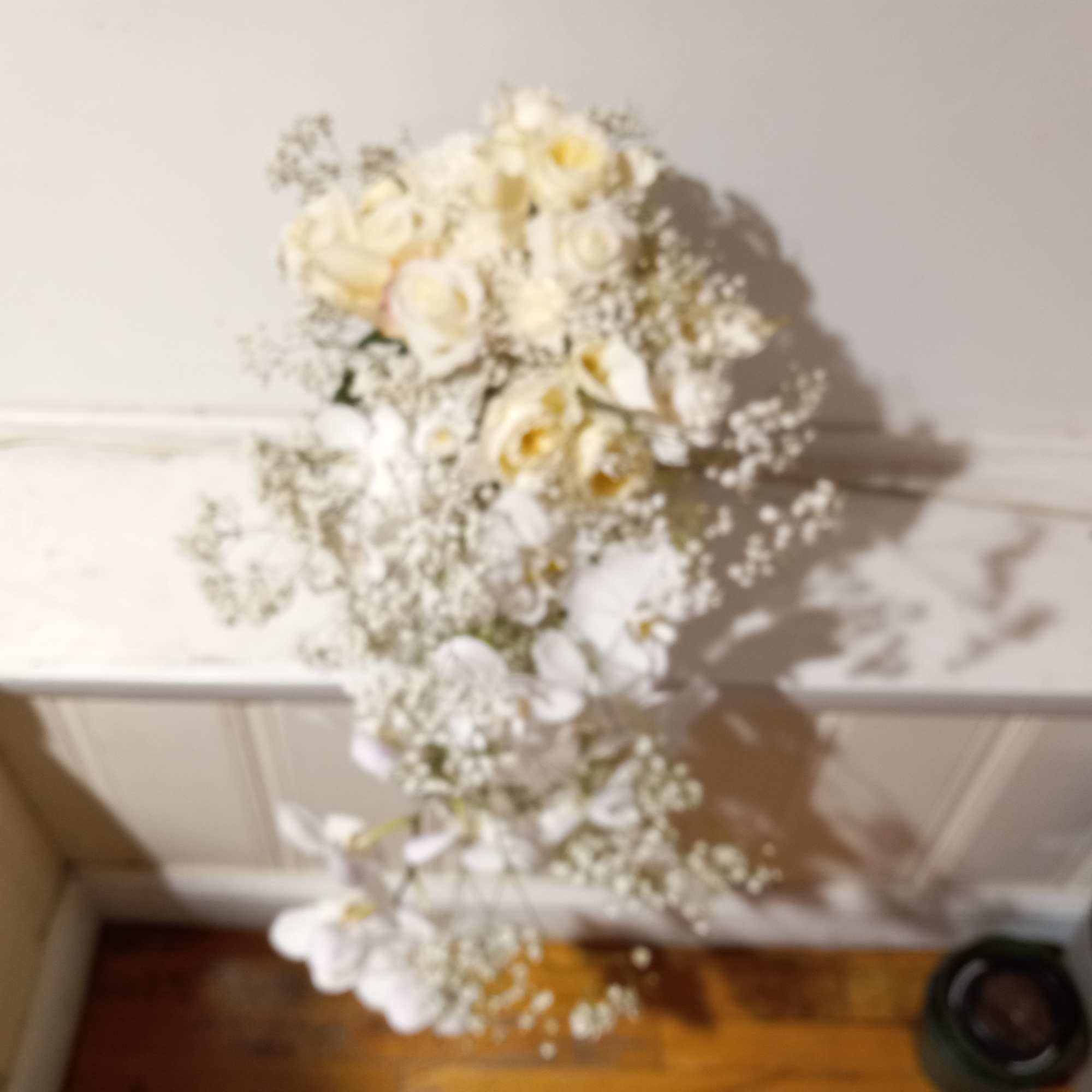 Beautiful white phalaenopsis orchids, roses, calla lilies and baby's breath bridal cascade