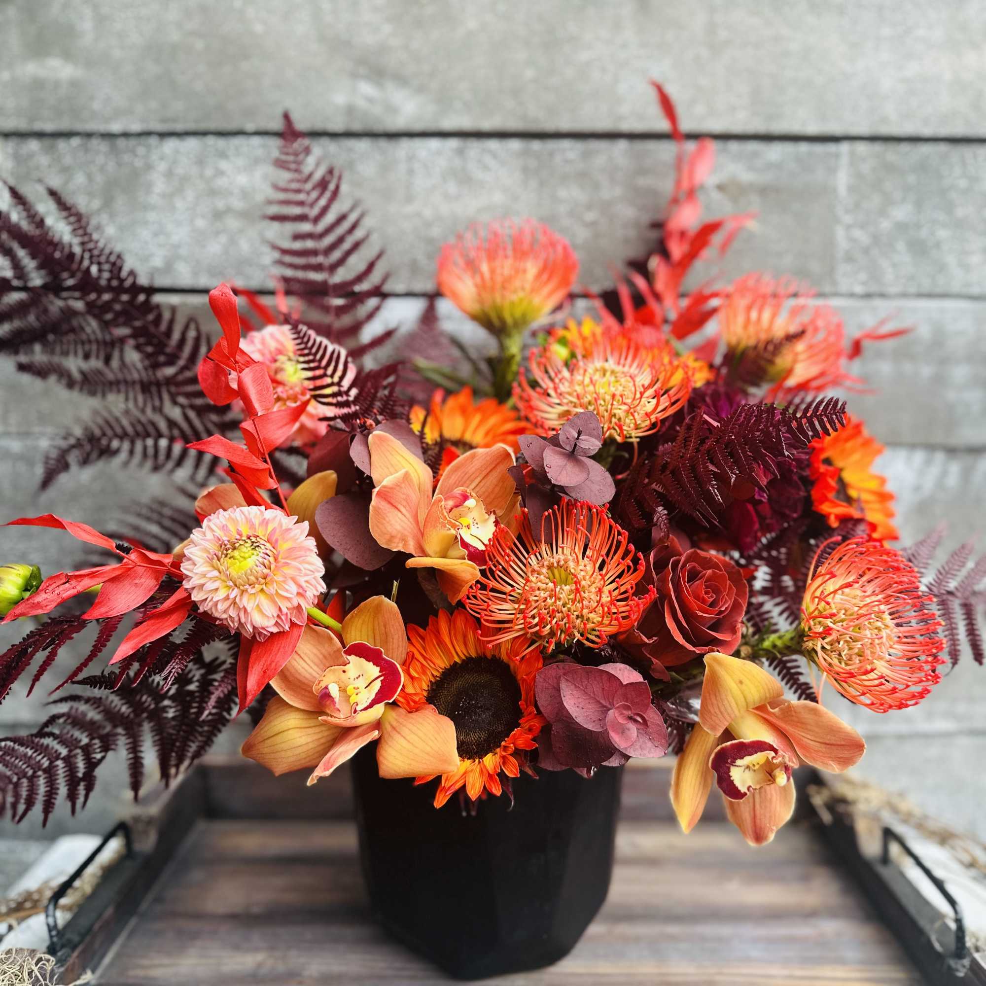 Proteas and orchids combined with preserved maple leaves Proteas and orchids combined with preserved maple leaves