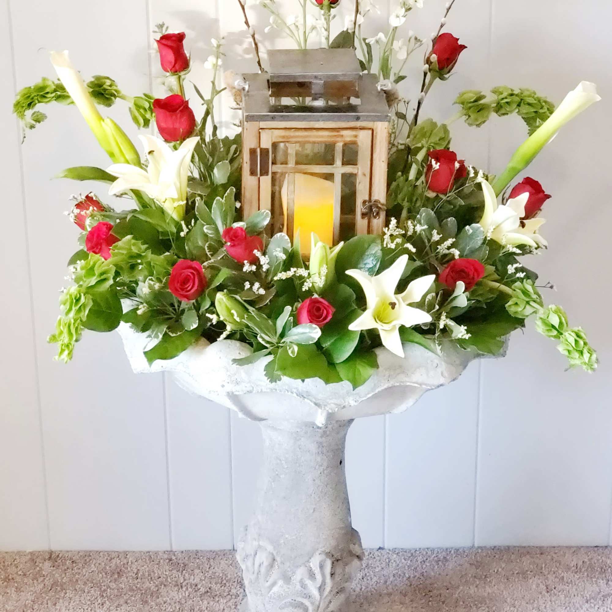Send a sweet sentimental arrangment in a cement birdbath that continues to