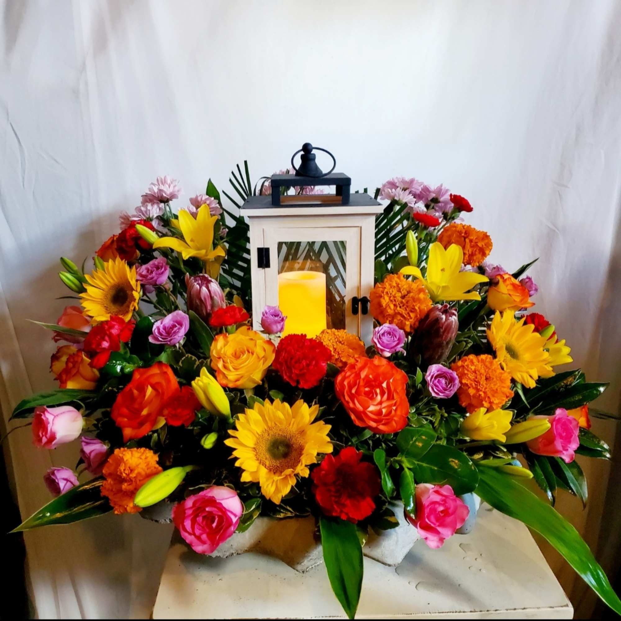 Send a sweet sentimental arrangment in a cement birdbath that continues to