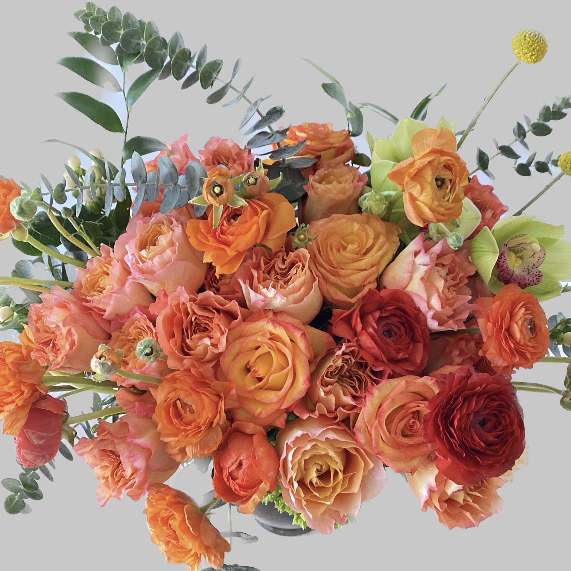 Fragrance fresh orange roses, orange ranunculus, touch of green within leaf lines