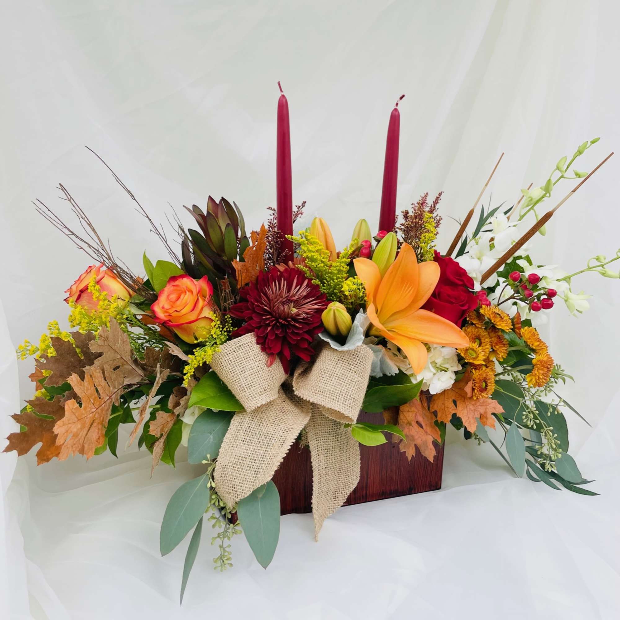 Box with an assortment of fall themed flowers.