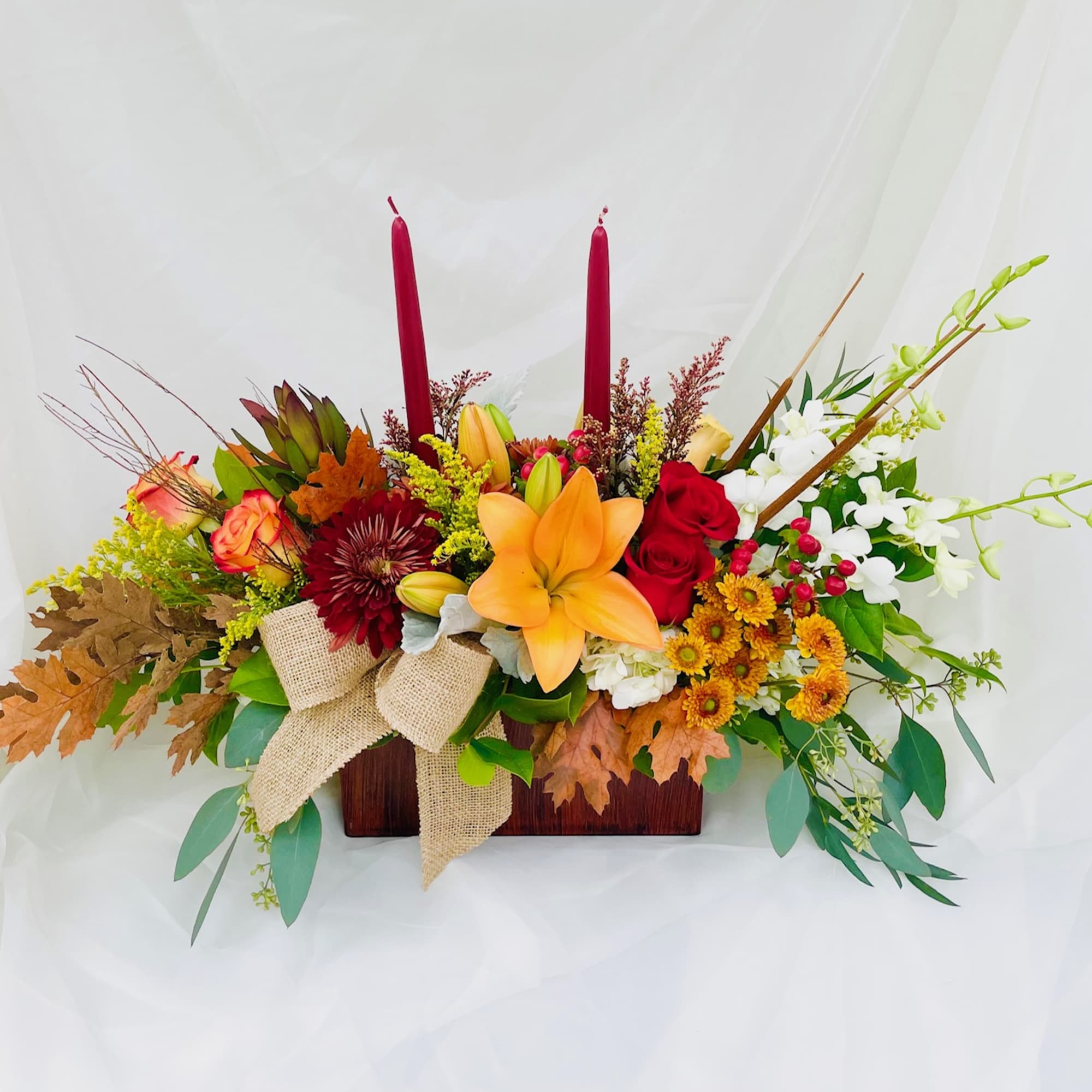 Box with an assortment of fall themed flowers.