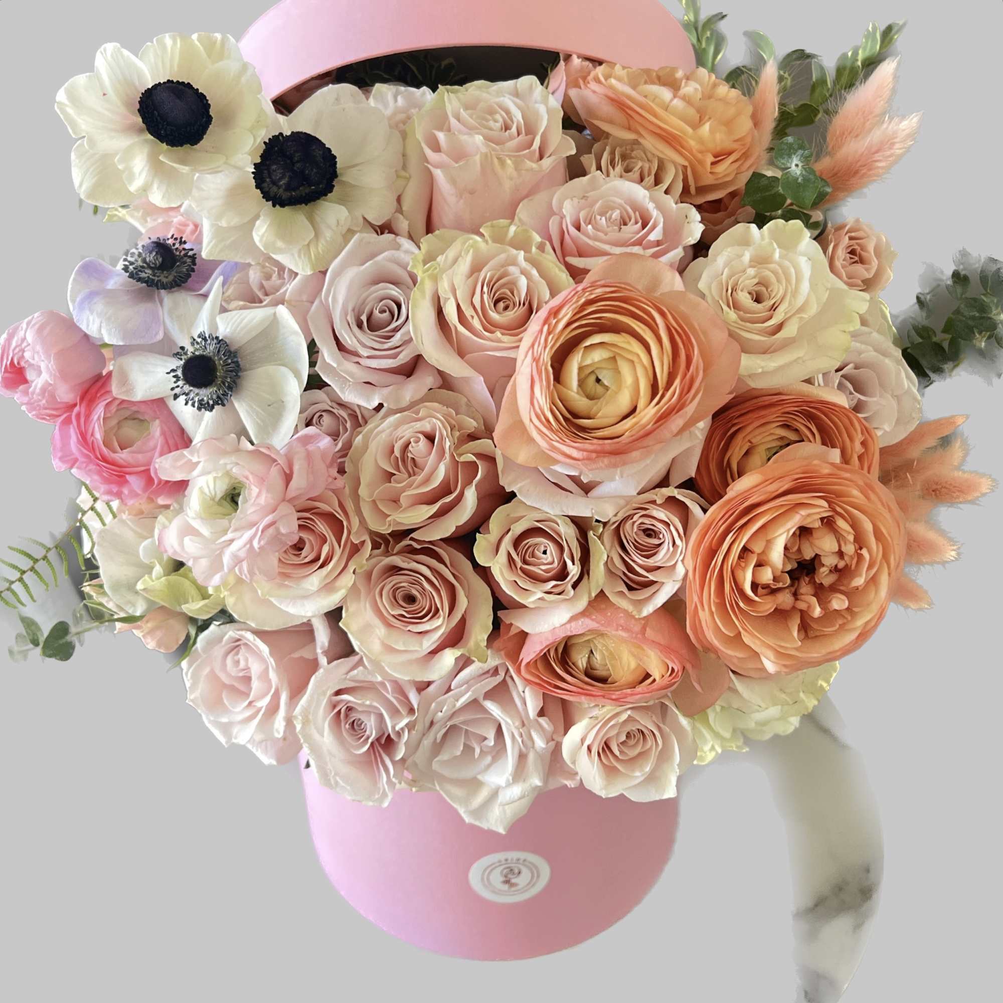 Mixed flower arrangement with pink hat box! 
The box size is 6