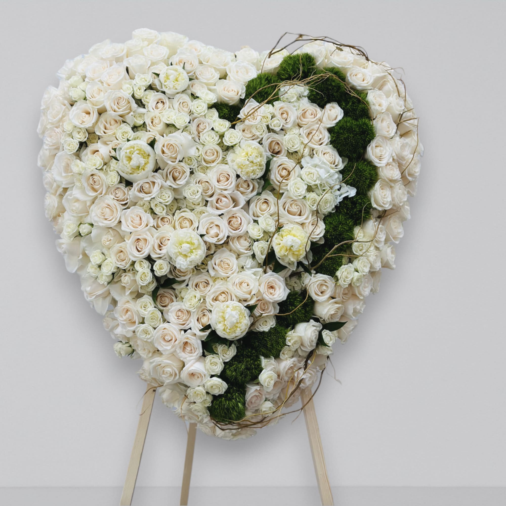 A beautiful full heart funeral arrangement. Filled with fresh florals, hydrangea, roses