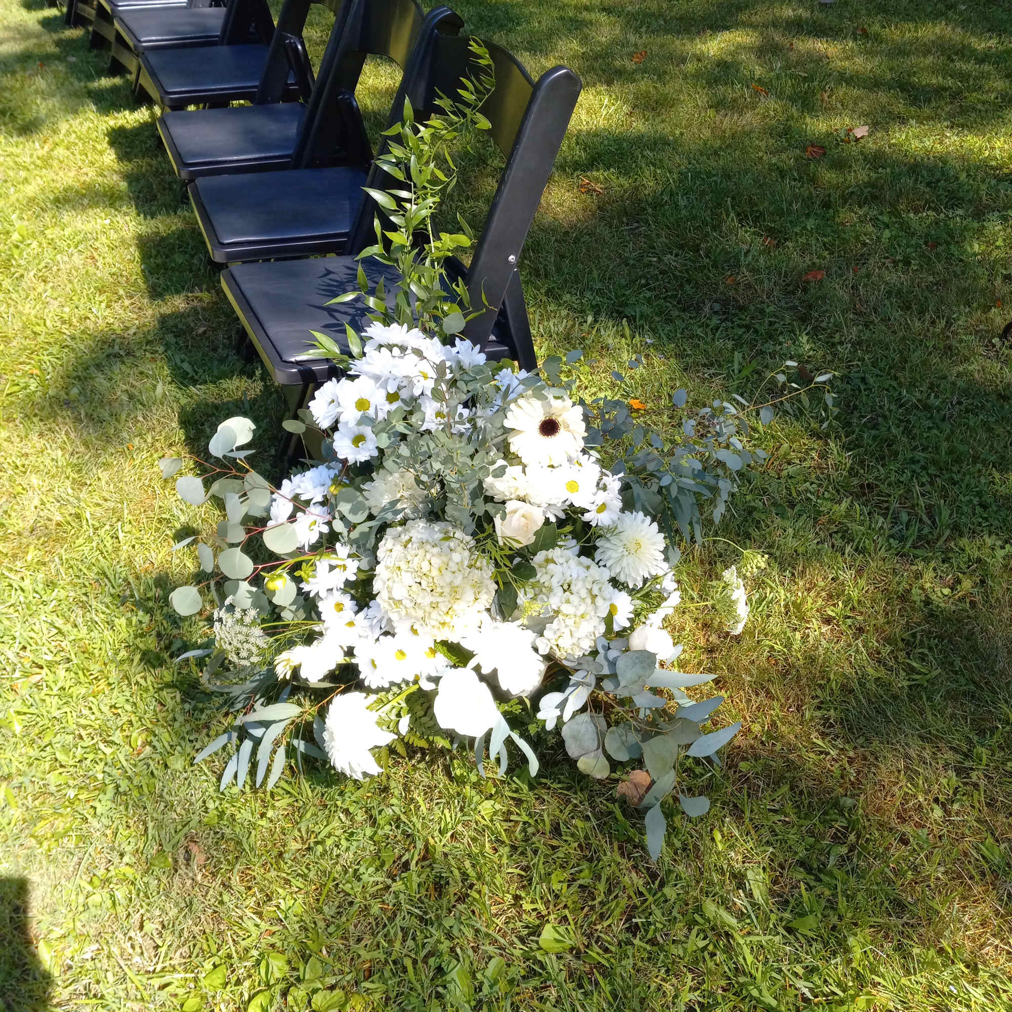 Beautiful all white roses, daisies, carnations and other flowers  pew side