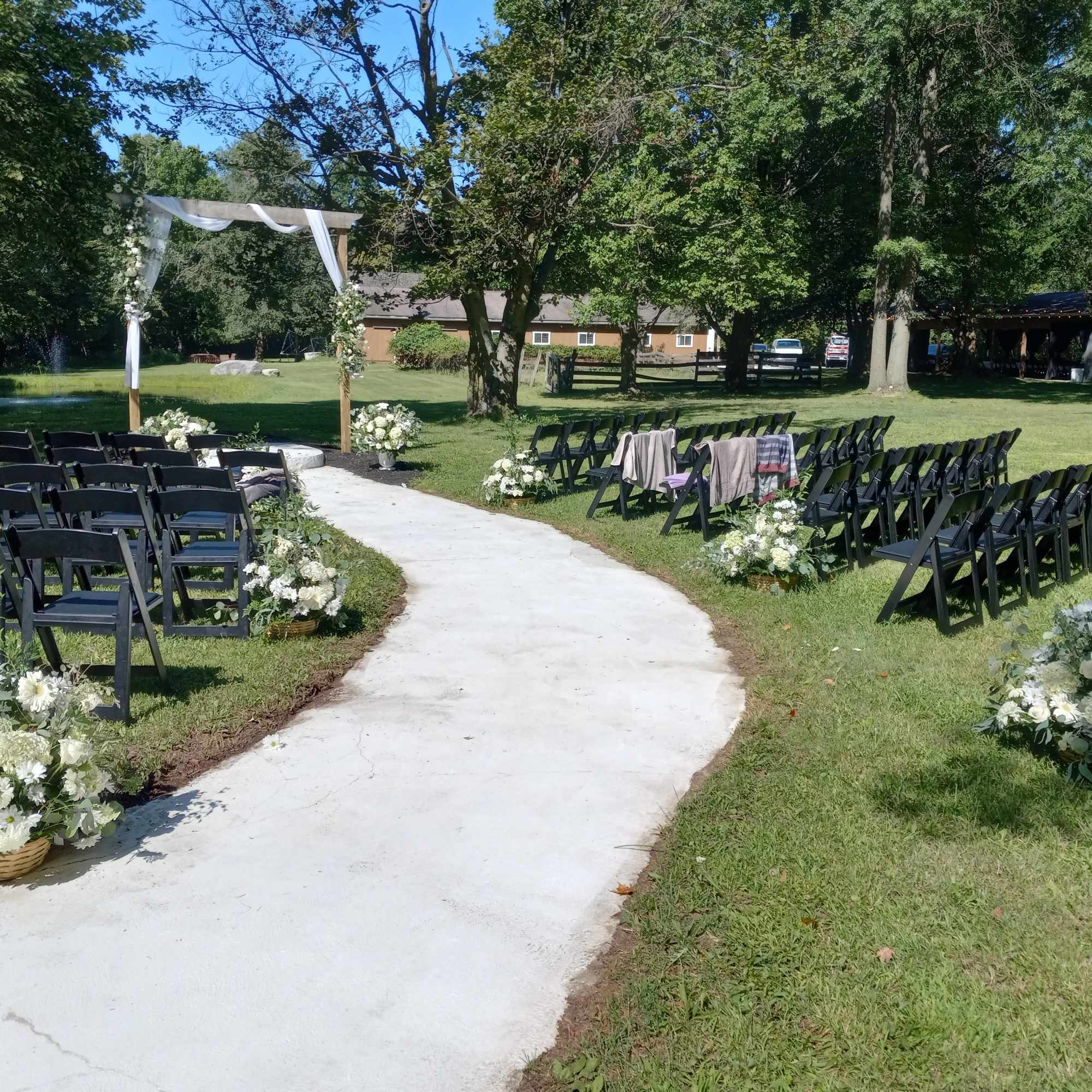 Beautiful all white roses, daisies, carnations and other flowers  pew side