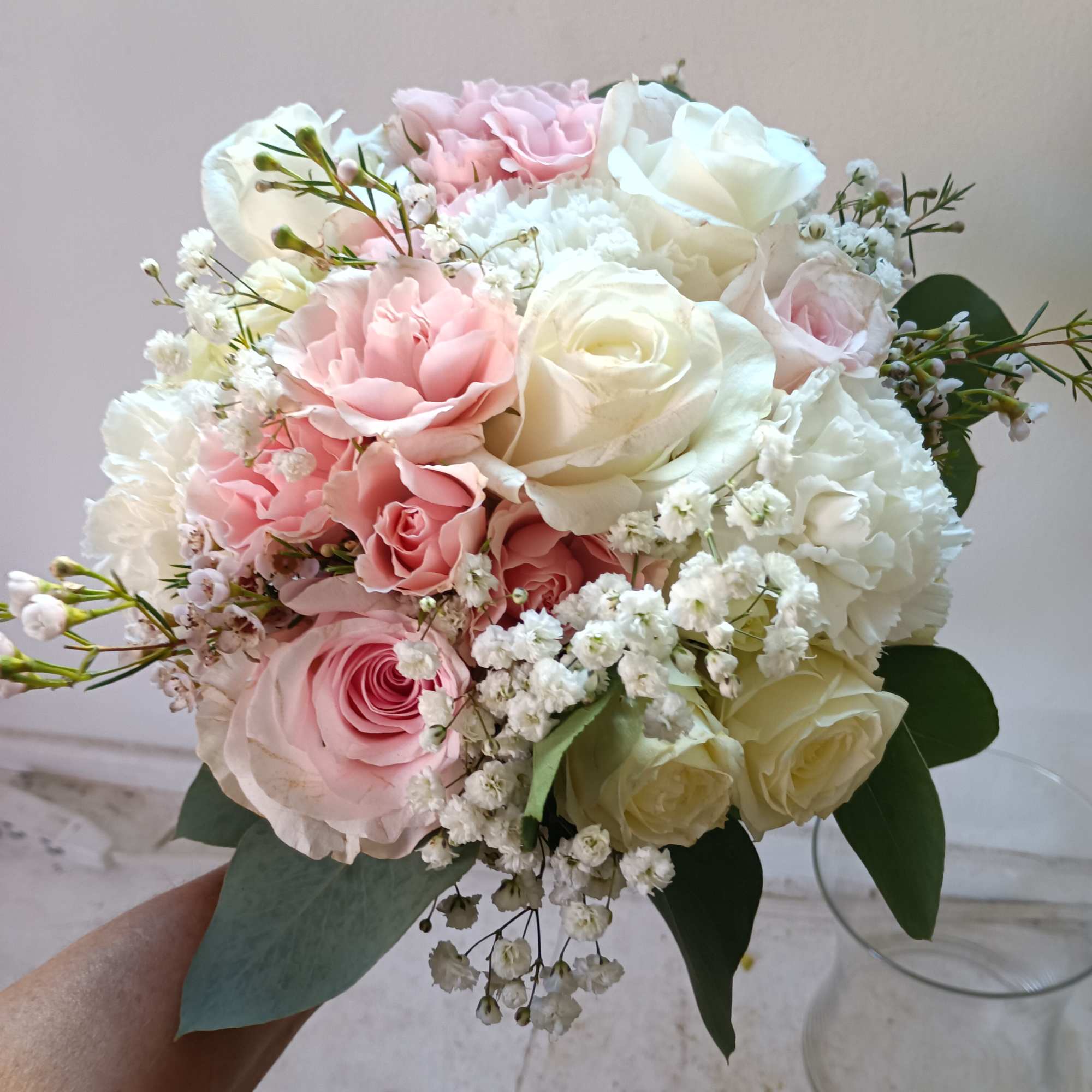 Light and airy white and light pink standard and spray roses, carnations