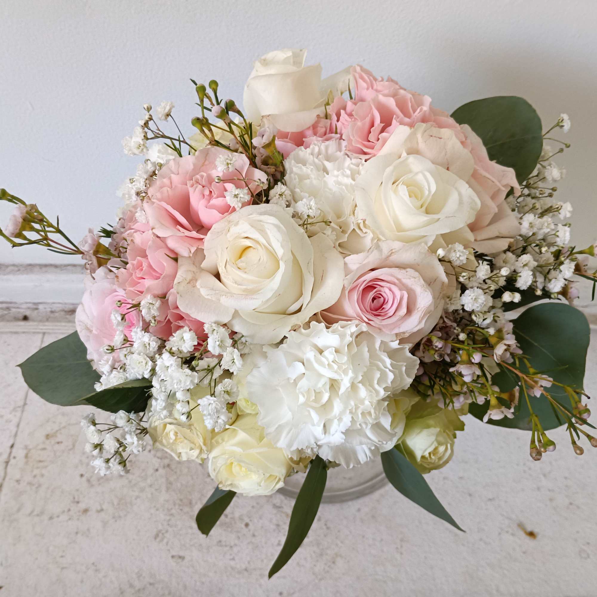 Light and airy white and light pink standard and spray roses, carnations